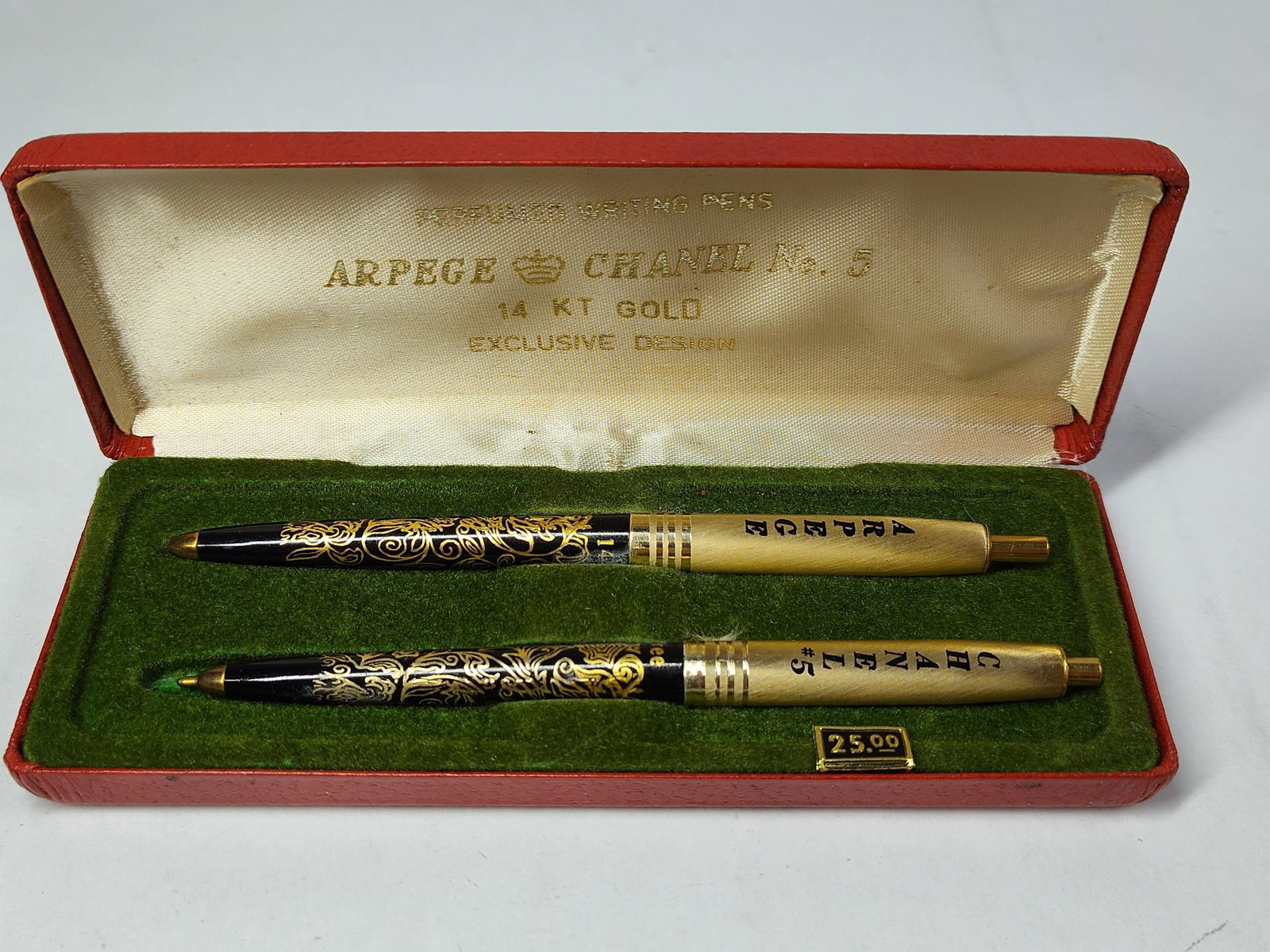 Set of ballpoint pens: A set of two retractable ballpoint pens presented in their original manufacturer gift case. The set includes one pen branded for the Arpege fragrance and one for Chanel No. 5. Each pen is constructed