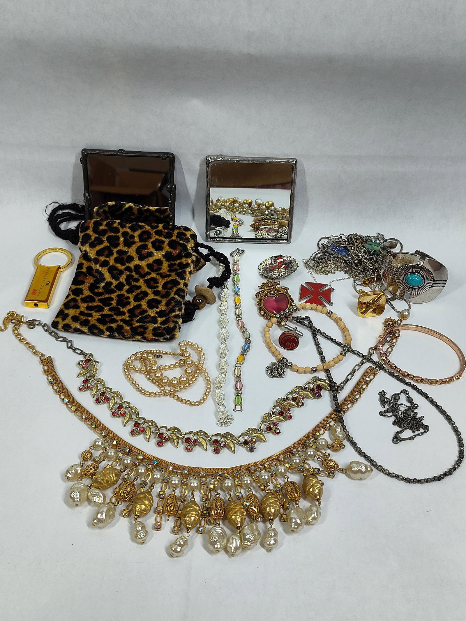 Givenchy & Michael Kors Jewelry & Accessories: This collection consists of approximately 60 pieces of and contemporary costume jewelry, commemorative pins, and fashion accessories. Marked items include a rose gold-tone hinged bangle with the
