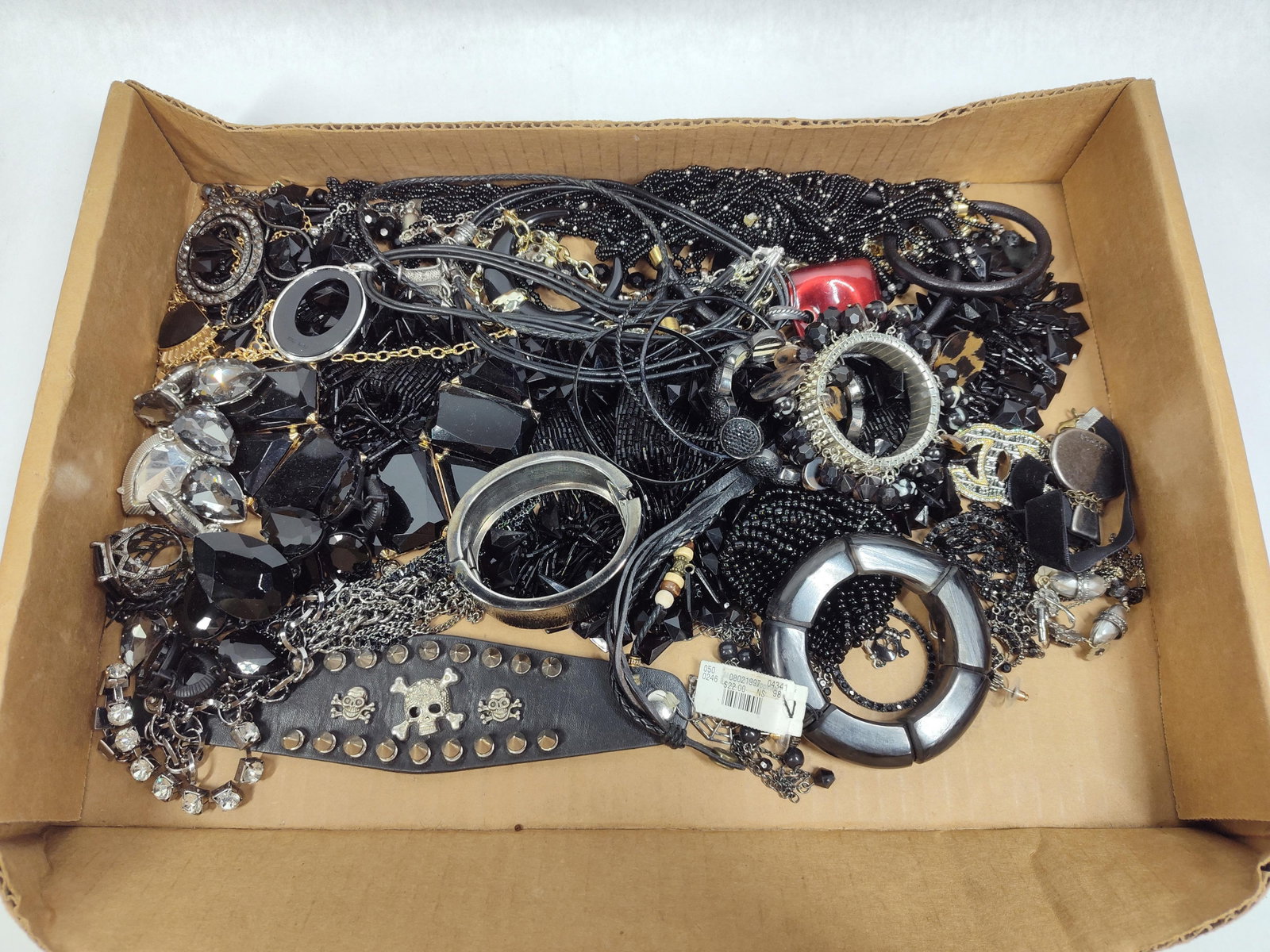 Nine West & Disney Black & Silver Costume Jewelry: This lot features an assortment of contemporary costume jewelry, primarily in a black and silver-toned color palette. The collection includes a variety of necklaces, bracelets, earrings, rings, and a