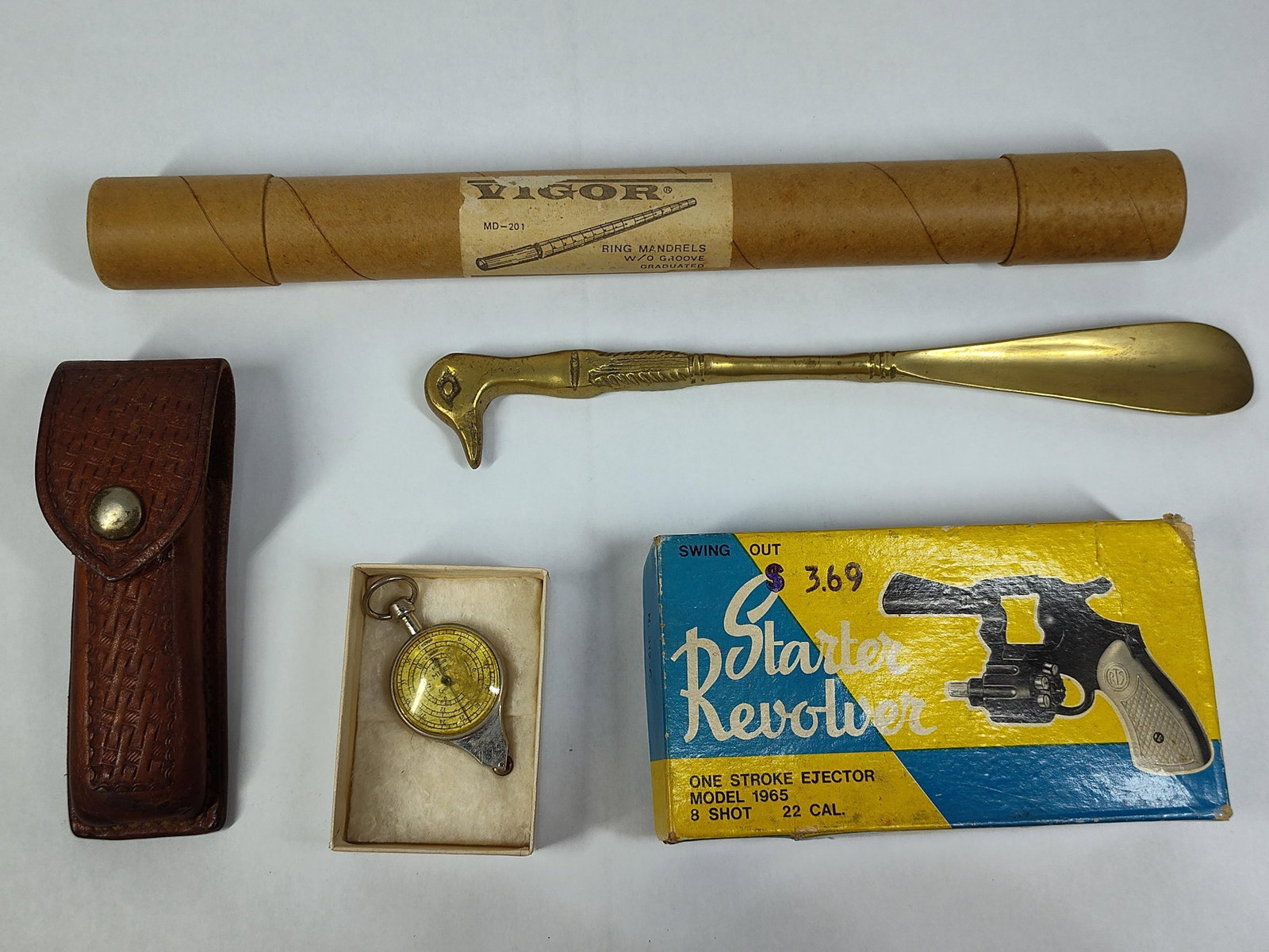 Tools, Sporting Goods & Collectibles: This collection features a diverse group of mechanical tools and collectibles. Included is a Model 1965 eight-shot starter revolver, a .22 caliber blank gun with a black finish and cream-colored