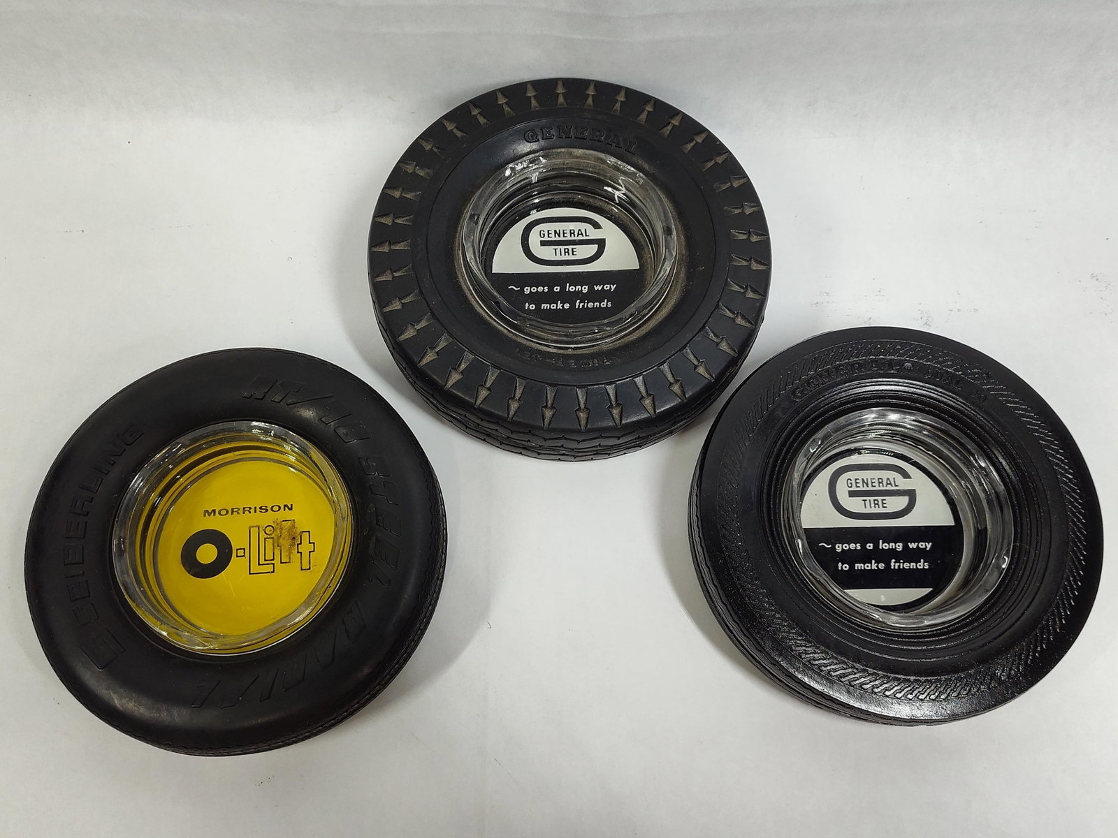 3 General Tire & Seiberling Tire Ashtrays: A set of three advertising tire ashtrays produced for promotional use in the mid-20th century. The collection includes three distinct miniature black rubber tires fitted with circular glass inserts.