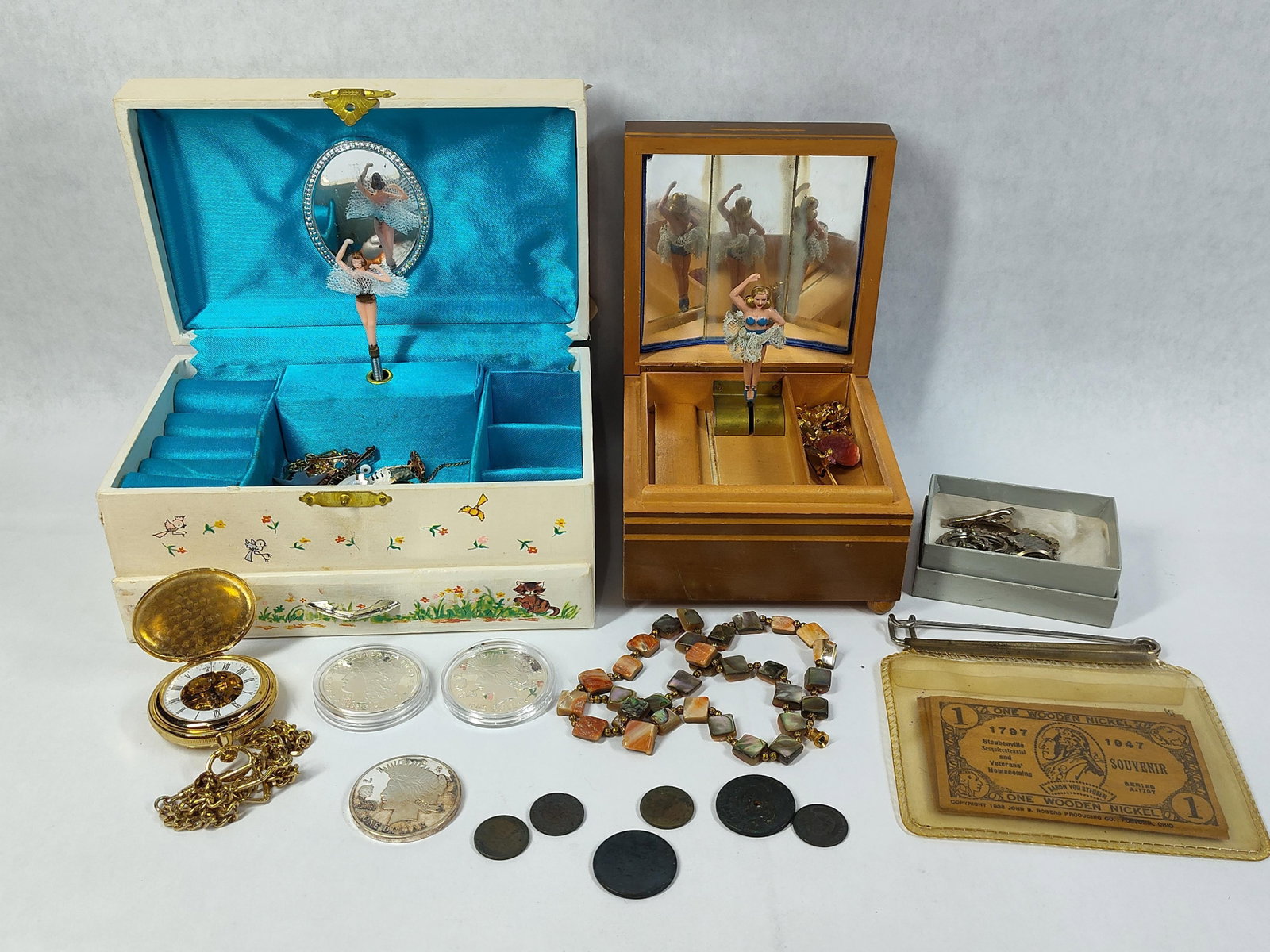 Berenger Skeleton Pocket Watch & Musical Boxes: A diverse collection of items headlined by two mechanical musical jewelry boxes and horological pieces. The first musical box is a Swiss-made wooden chest labeled from Musikhaus Hug and Co., Basel, fe