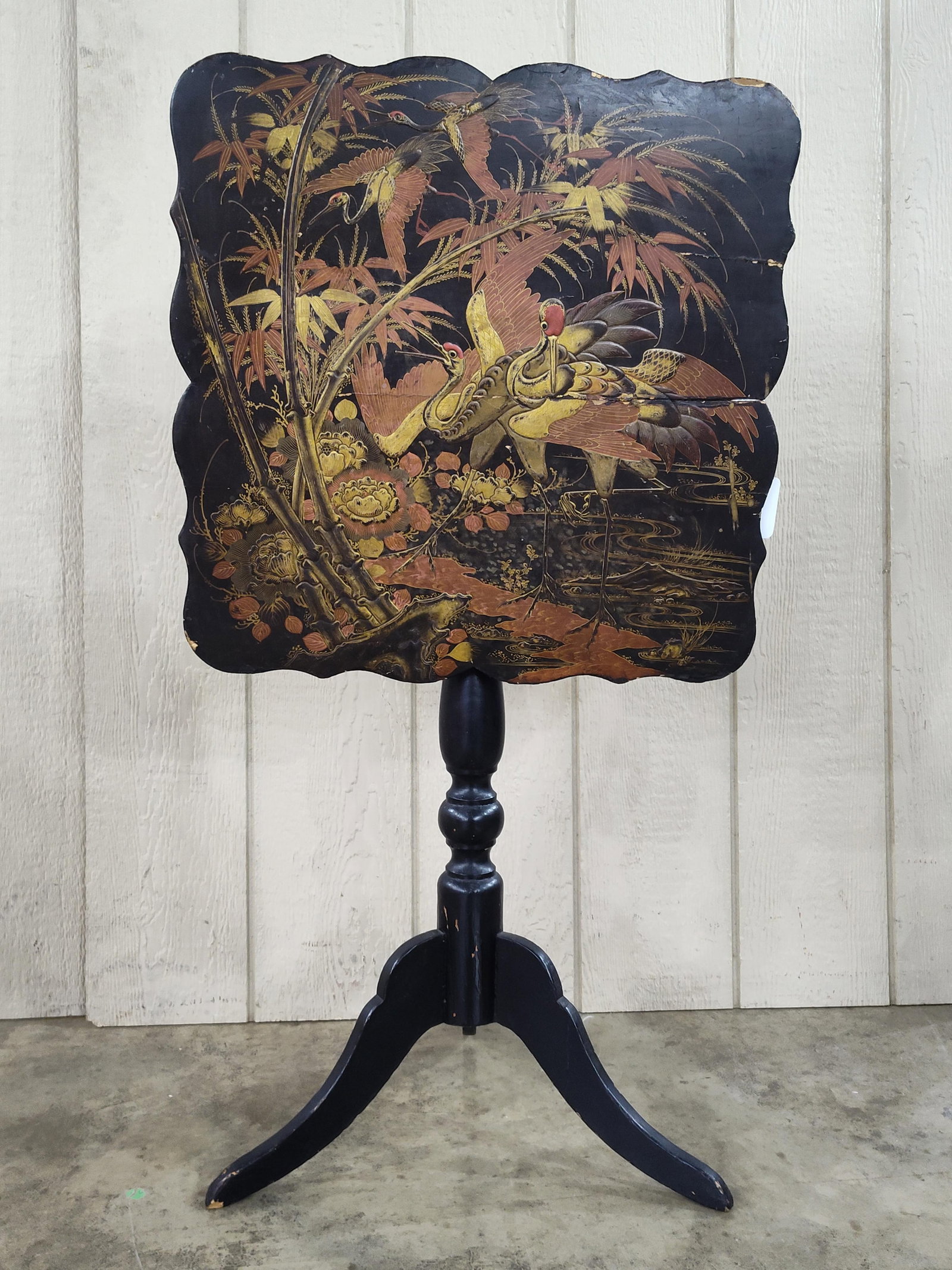 Chinoiserie Japanned Wood Tilt-Top Tripod Table: 21.5 x 28. A Chinoiserie style tilt-top side table featuring a black japanned finish over wood. The square top is designed with deeply scalloped edges and displays a hand-painted scene of three
