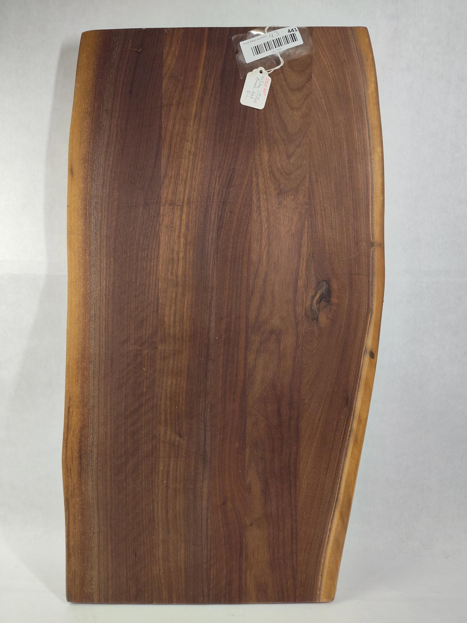 Live-Edge Black Walnut Cutting Board: 14 x 26. A live-edge cutting or charcuterie board constructed from black walnut wood. The board displays a dark brown heartwood center framed by lighter sapwood along the natural, irregularly