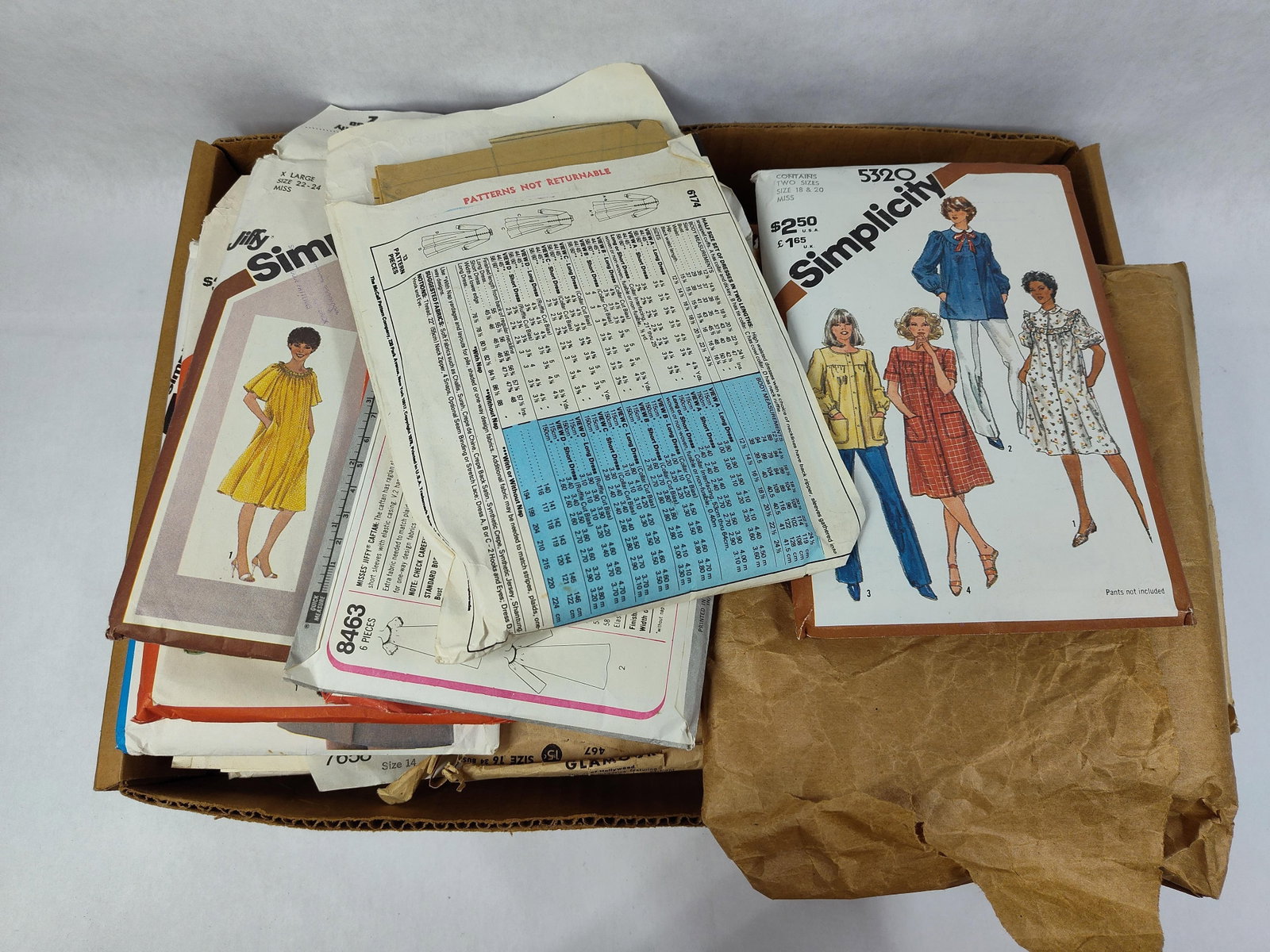Simplicity, McCall's & Advance Sewing Patterns: This large collection of sewing patterns includes designs from several prominent American manufacturers, primarily Simplicity, McCall's, Advance, and Glamour. The lot encompasses a diverse range of
