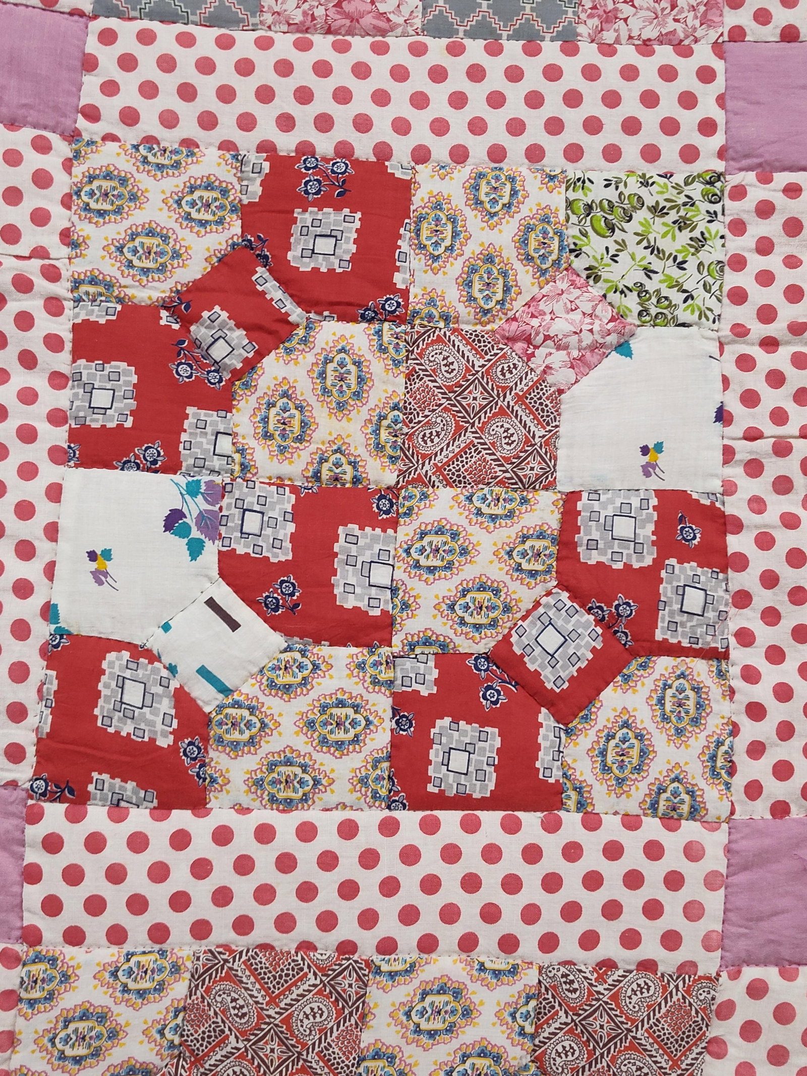 Hand-Pieced & Quilted Scrappy Cotton Quilt: This is a handmade patchwork quilt constructed from various printed and solid cotton fabrics. The quilt top features a variation of the Snowball or Bowtie block pattern, utilizing a wide range of