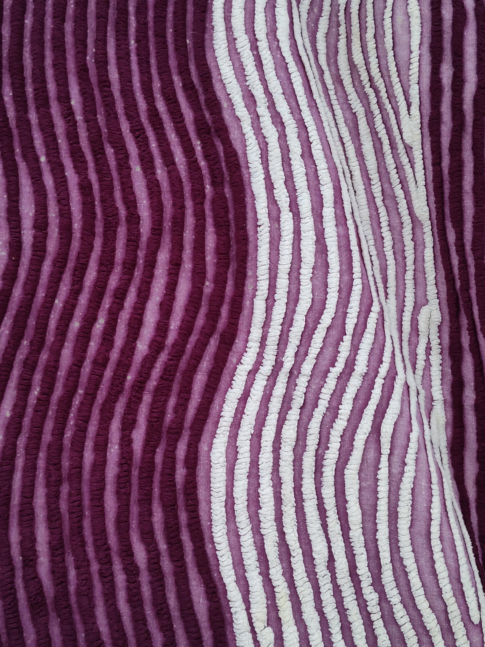 Mid-C. Purple & White Tufted Chenille Bedspread: A vintage mid-20th century tufted chenille bedspread featuring a deep plum purple cotton ground. The textile is decorated with cotton yarn tufting in white and purple. The central rectangular field di