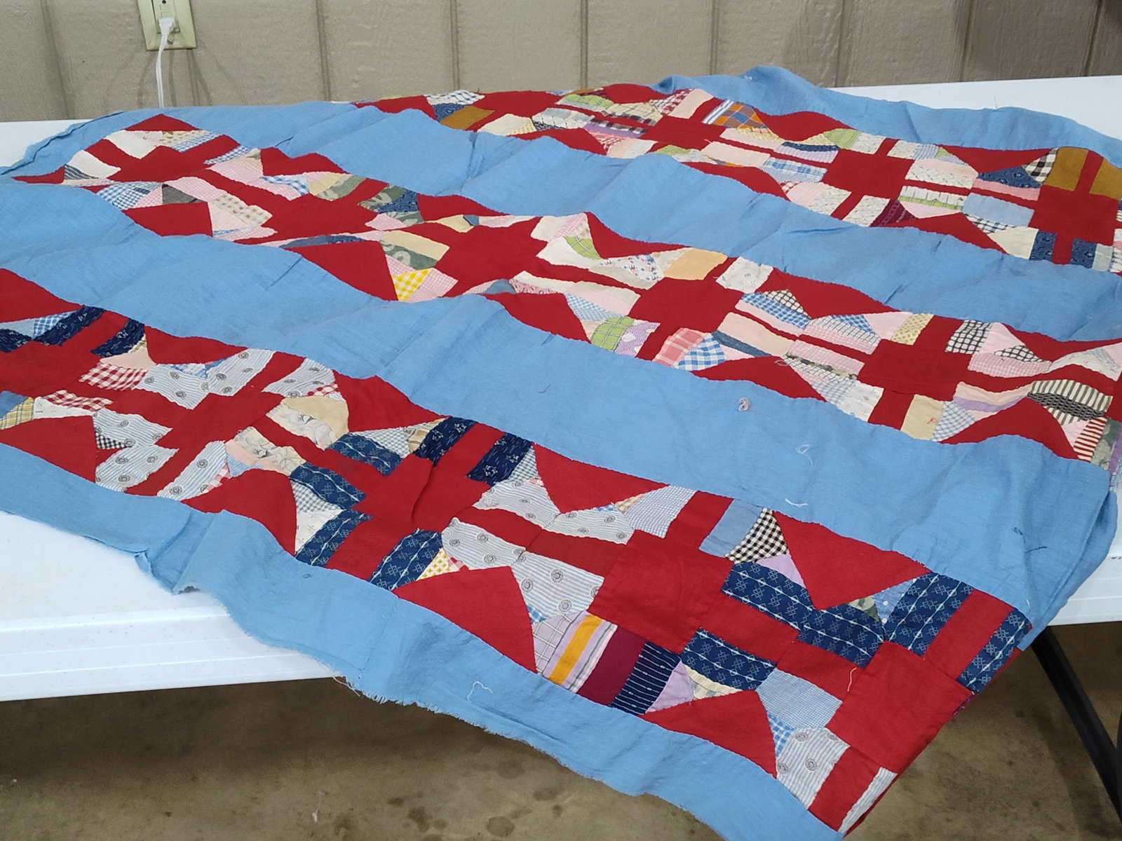 American Hand-Pieced Cotton Patchwork Quilt Top: This item is a vintage American patchwork quilt top featuring a hand-pieced construction. The textile is an unfinished top, lacking batting, backing, and binding. It is composed of assorted cotton