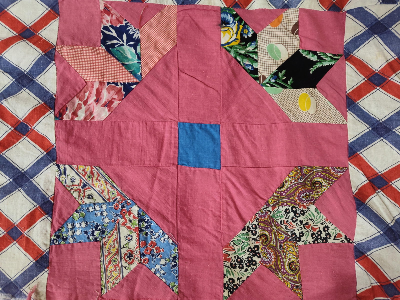Mid-20th C. Lemoyne Star & Plaid Cotton Quilt Top: A hand-pieced quilt top constructed from assorted cotton fabrics. The design features alternating blocks of an eight-pointed Lemoyne Star pattern and a red, white, and blue plaid cotton fabric. The st