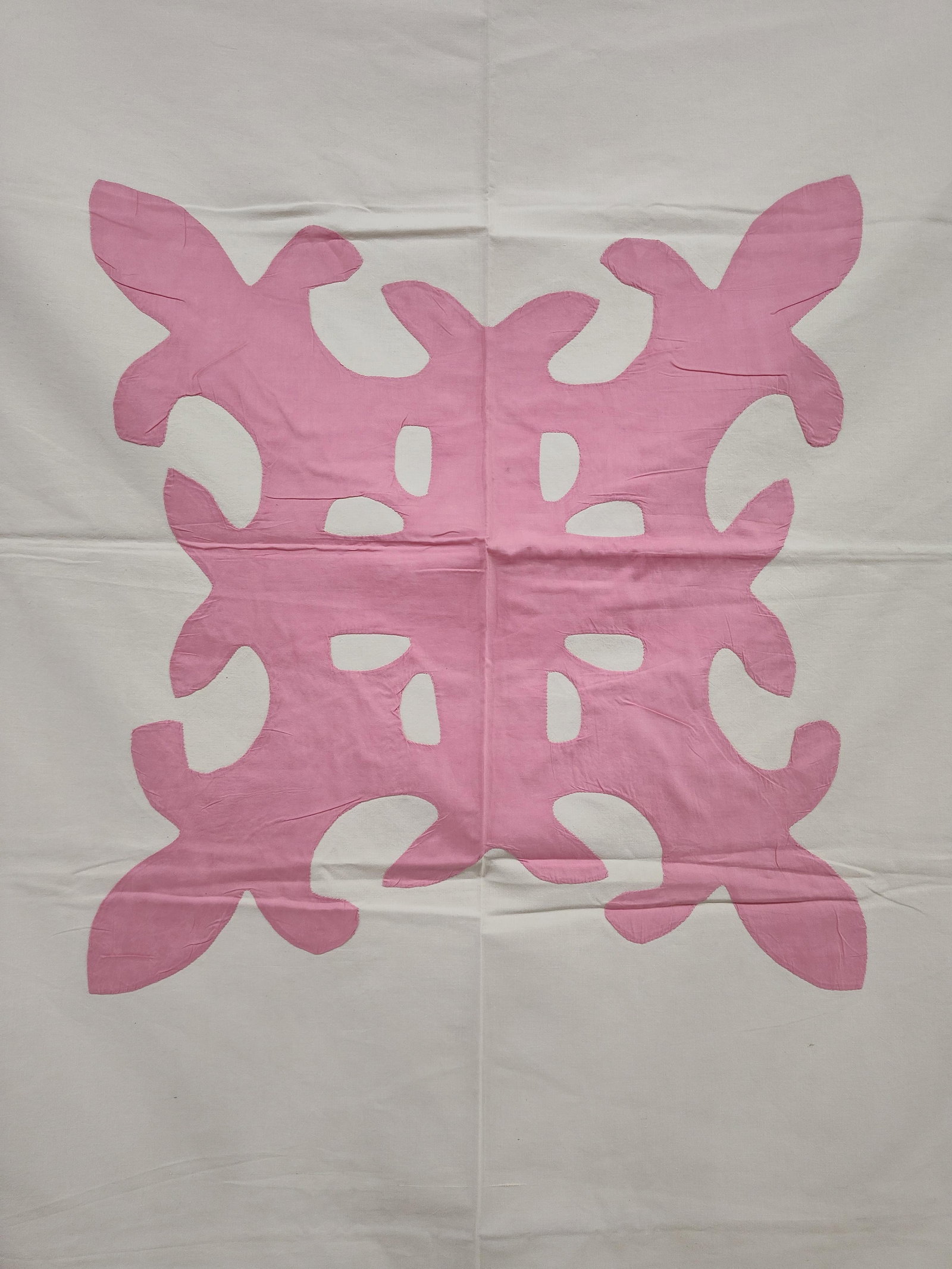 Hawaiian Style Pink and White Applique Quilt Top: This square textile is an unquilted top or decorative coverlet featuring a traditional Hawaiian-style applique design. The ground is composed of a single layer of white plain-weave fabric, likely a co