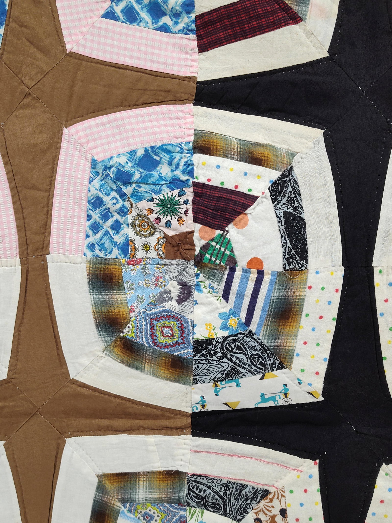 American Hand-Stitched Spider Web Scrap Quilt: This hand-stitched American scrap quilt is executed in the Spider Web pattern, also referred to as a Kaleidoscope design. The quilt top is comprised of numerous cotton and cotton-blend fabric scraps