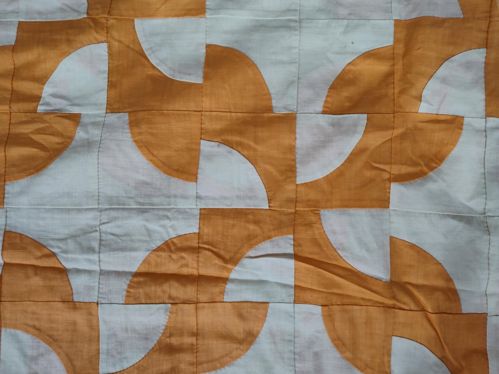 Mid-20th C. Drunkard's Path Cotton Quilt Top: A vintage hand-pieced quilt top featuring the traditional Drunkard's Path pattern. The design is composed of square blocks with inset quarter-circles, arranged to create a repeating motif of