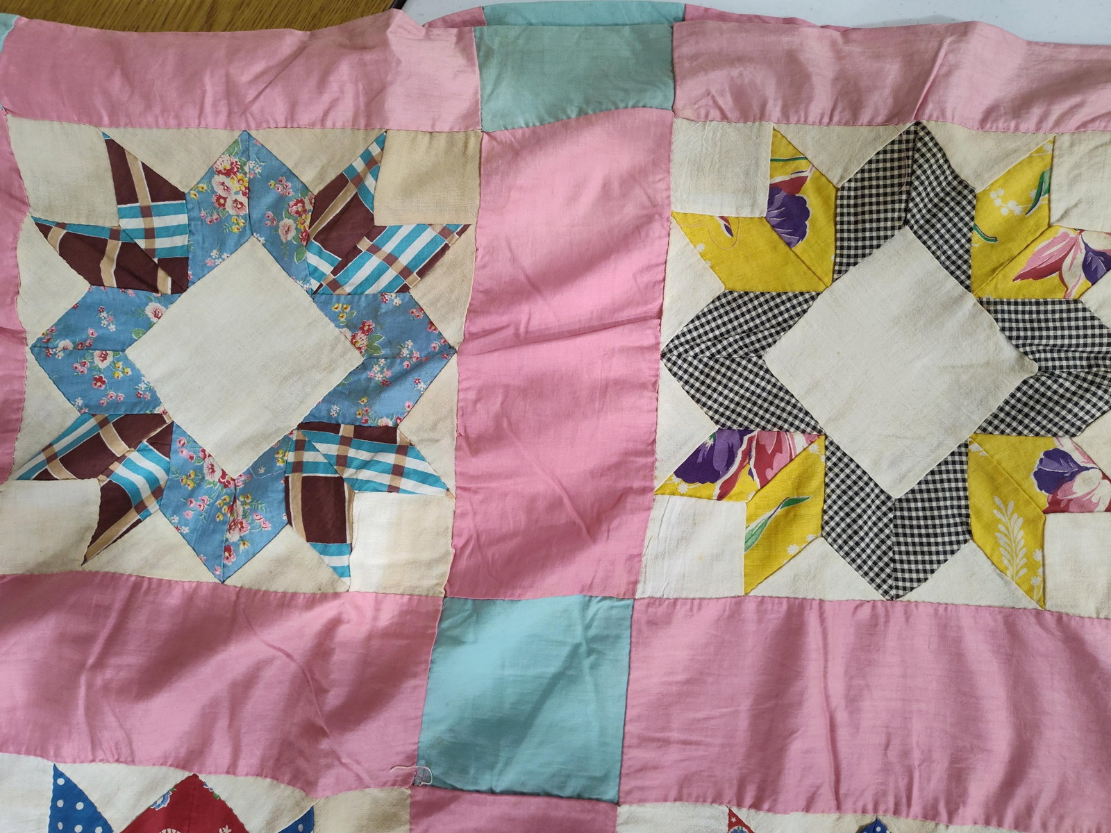 Mid-20th C. Hand-Pieced Star Pattern Quilt Top: A hand-pieced quilt top featuring large eight-pointed star blocks, a variant of the LeMoyne Star or Lone Star pattern. This unfinished textile is constructed from a wide variety of printed and