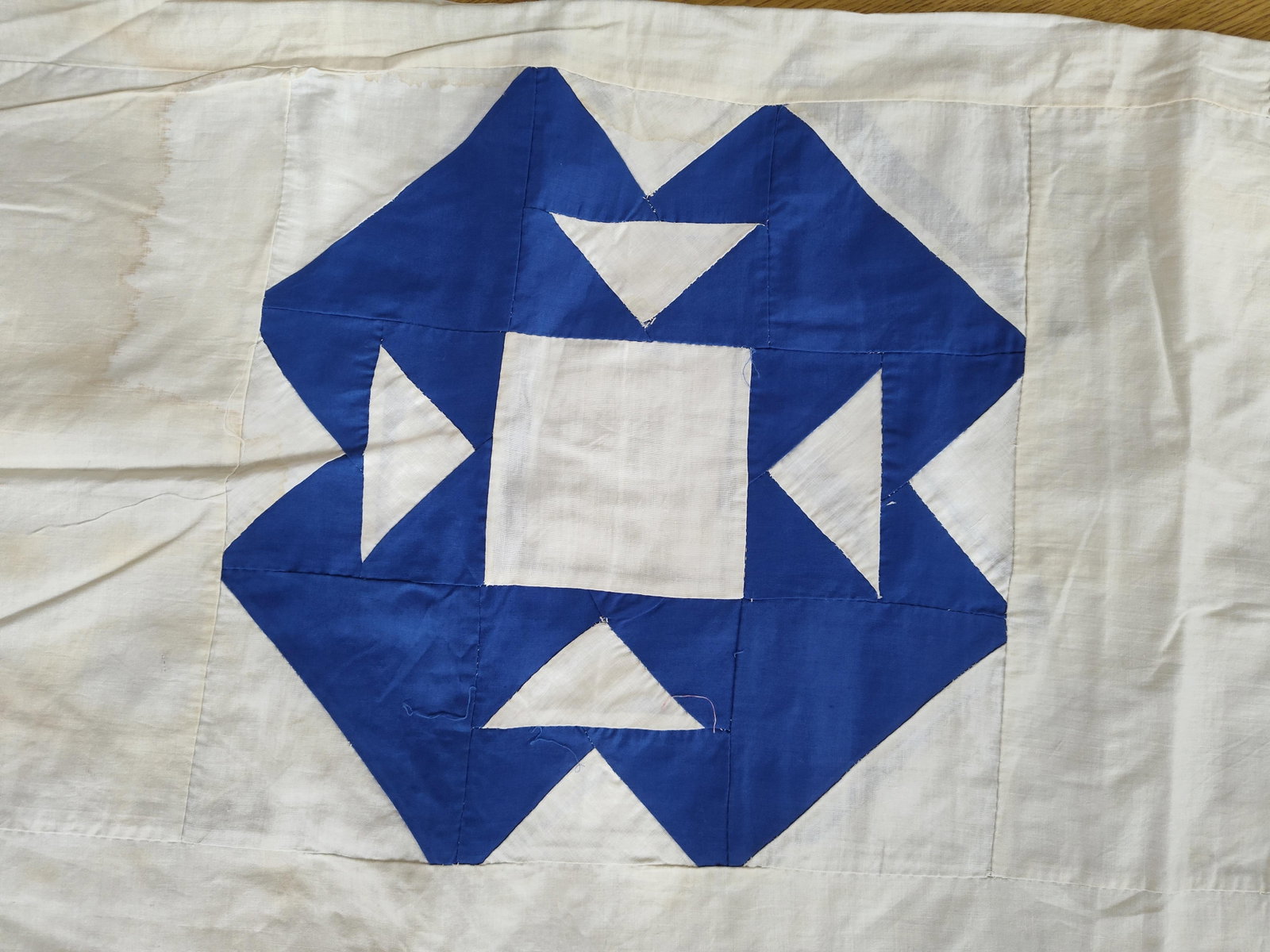 American Cotton Quilt Top, Cut Glass Dish Pattern: This hand-pieced cotton quilt top features a two-color geometric design in cobalt blue and off-white. The textile is composed of eight blocks arranged in a two-by-four grid, with each block separated 
