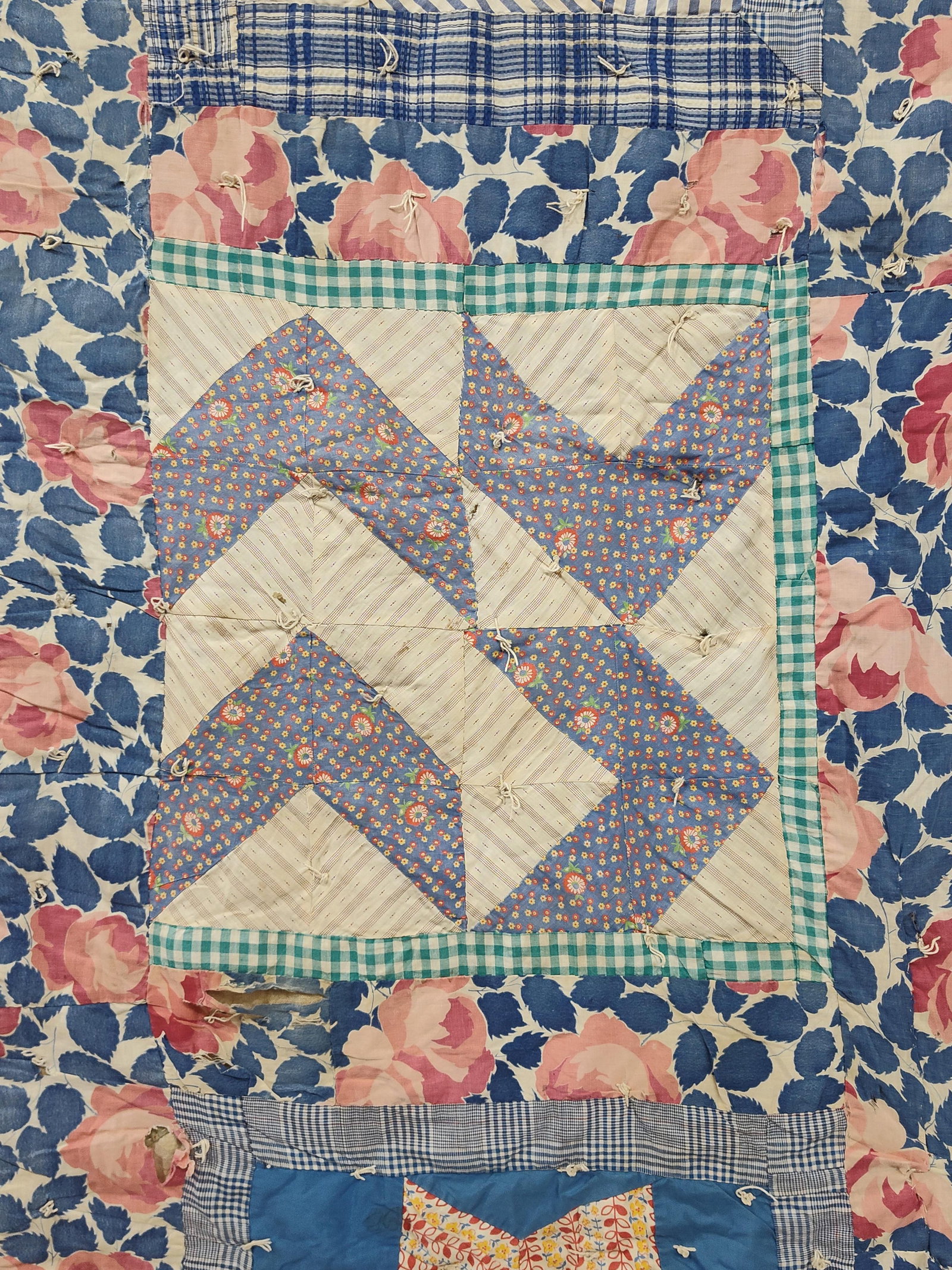 American Mid-20th C. Reversible Patchwork Quilt: A reversible, hand-pieced, and hand-tied cotton patchwork quilt. One face features a large central square with a blue and white floral chevron pattern, surrounded by eight-pointed star blocks. These e