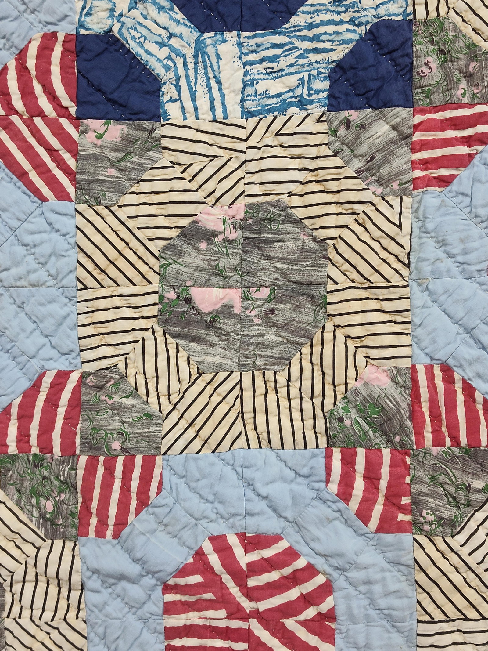 American Geometric Patchwork Quilt, mid-20th C: This hand-quilted American patchwork quilt features a geometric scrappy layout utilizing a block pattern variation reminiscent of Snowball and Rolling Stone designs. The composition is centered on