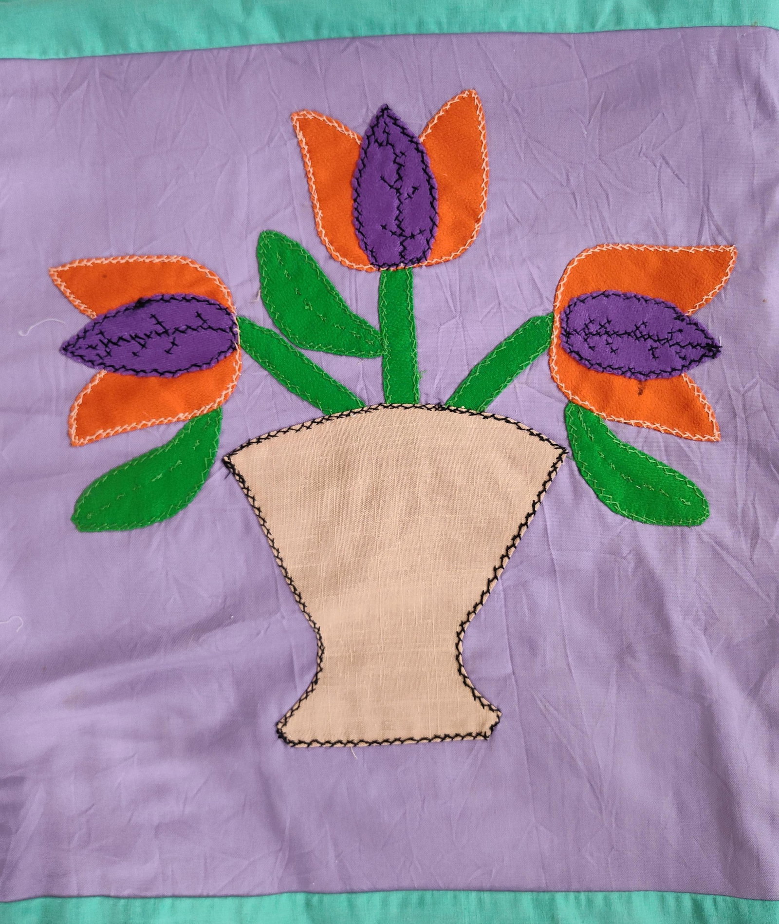 Mid-20th C. Hand-Appliqued Floral Cotton Quilt Top: This is an unfinished handmade applique quilt top featuring a stylized floral motif. The piece is constructed from a lavender-purple cotton or cotton-blend ground fabric with turquoise-aqua sashing