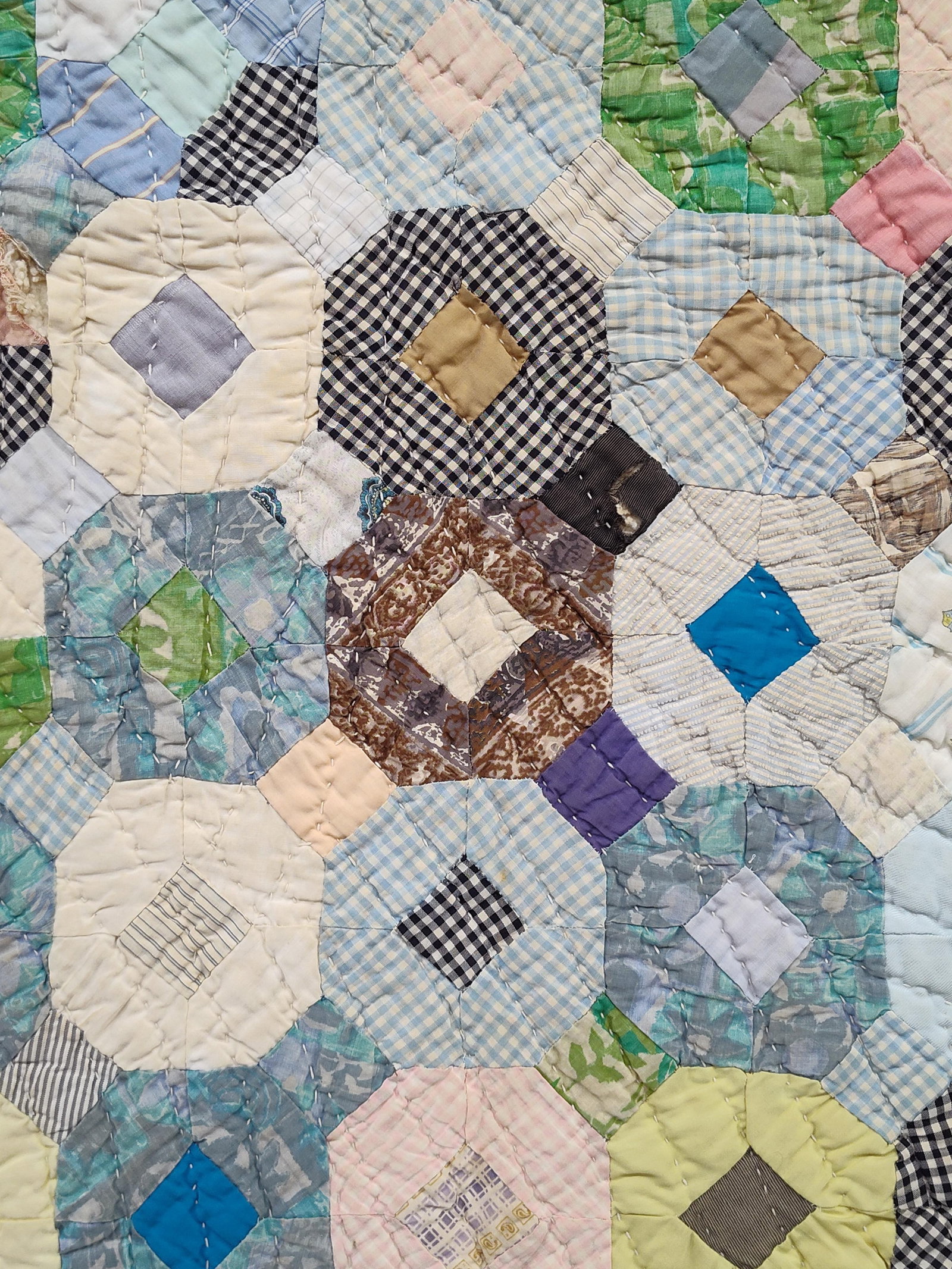 Antique American Octagonal Pattern Scrap Quilt: An antique American scrap quilt featuring a geometric pattern composed of octagonal blocks with central diamond-shaped squares, a design sometimes referred to as a Stone Mason's or Octagonal Bowtie va