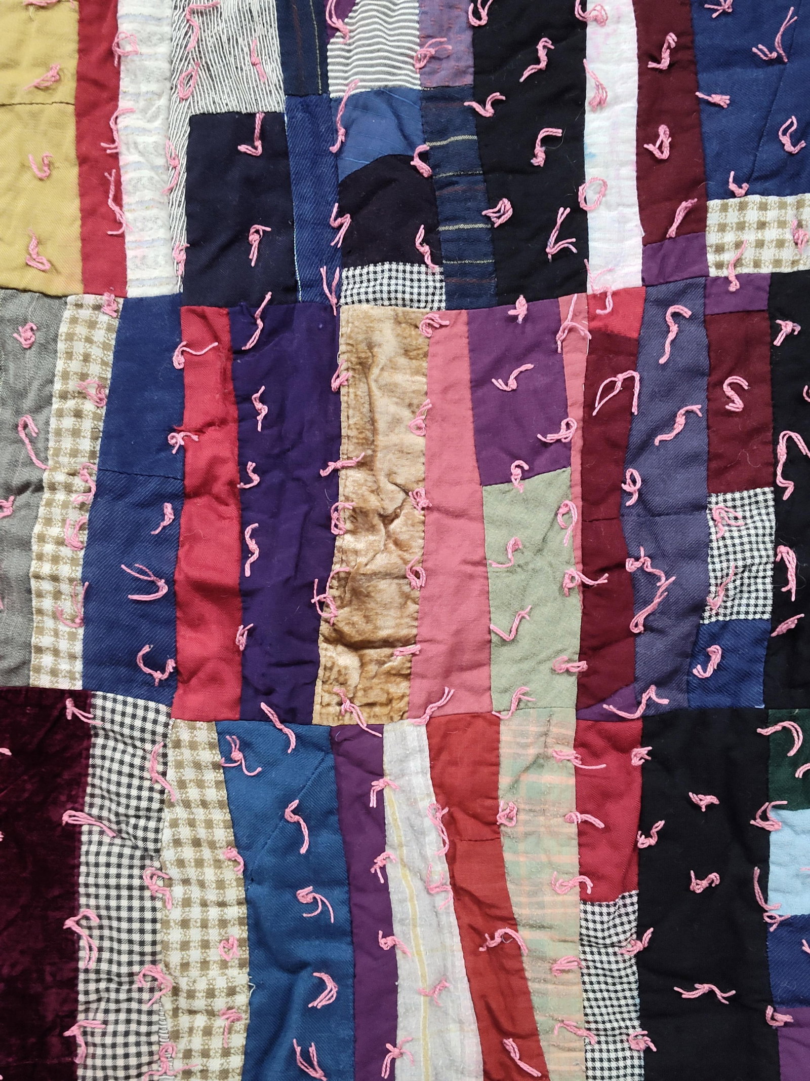 American Patchwork Quilt w/ Embroidered Border: A large handmade American folk art tied scrap quilt featuring an eclectic patchwork top. The construction consists of irregular rectangular and square patches in a style reminiscent of a utility crazy