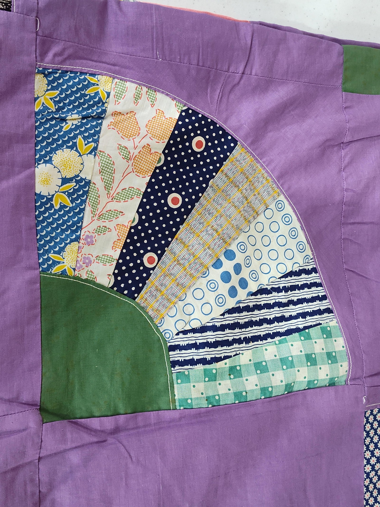 Grandmother's Fan Pattern Quilt Top: This is a vintage American quilt top featuring the Grandmother's Fan pattern. The piece consists of machine-pieced blocks joined together to form a larger textile, currently in an unfinished state