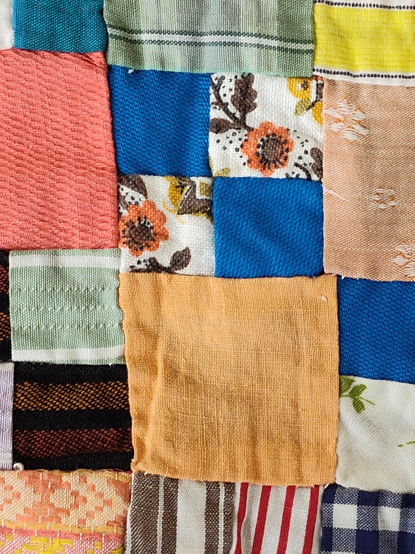 Mid-20th C. Hand-Stitched Scrap Patchwork Quilt: This unfinished patchwork quilt top is a hand-sewn example of mid-20th-century American utility quilting. The piece is constructed from an extensive assortment of recycled textile scraps, including pr