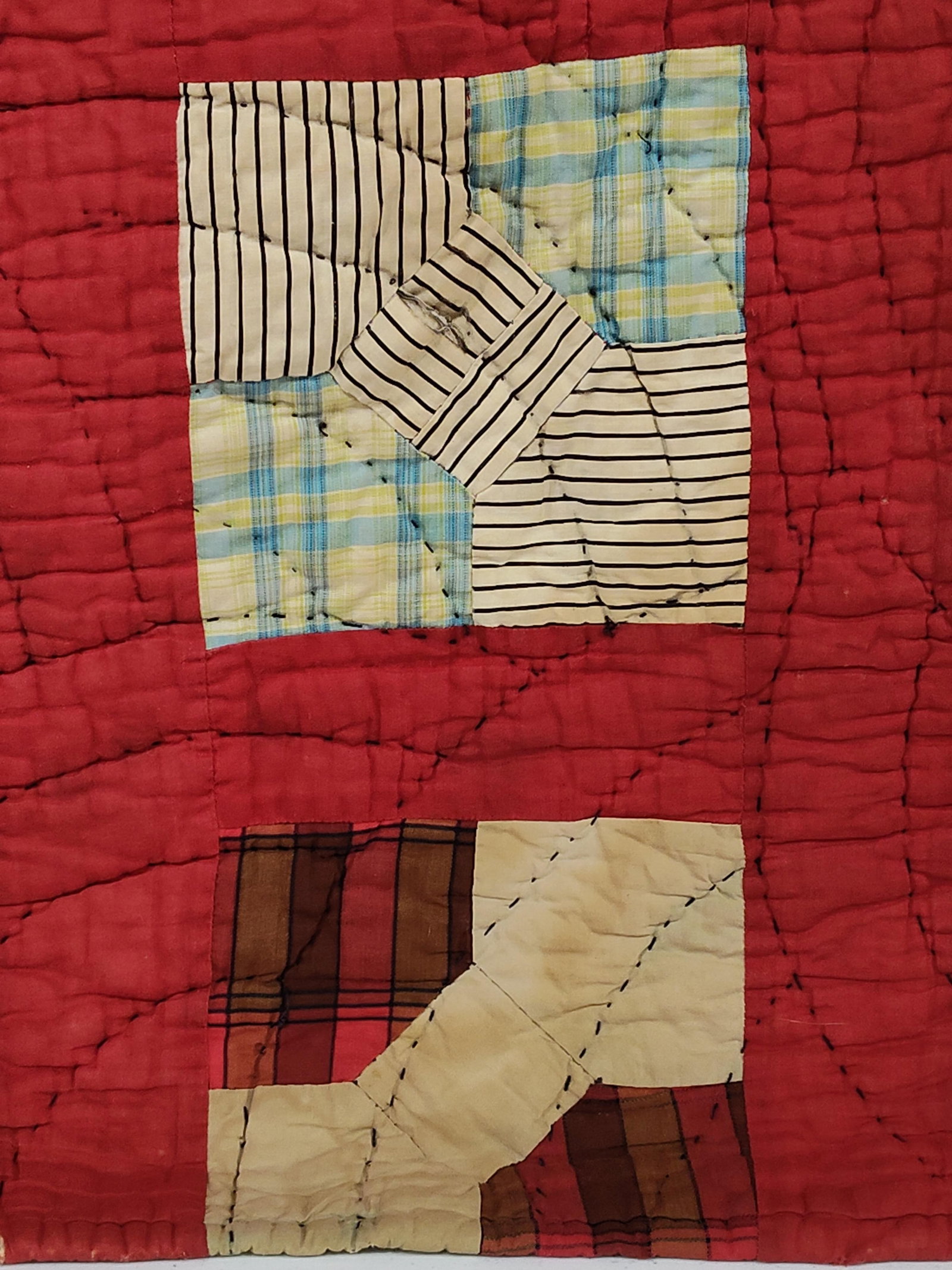 American Hand-Quilted Bow Tie Pattern Quilt: This textile is a traditional American utility quilt featuring a hand-pieced Bow Tie block pattern. The design consists of 48 individual square blocks arranged in a six-by-eight grid. Each block is se