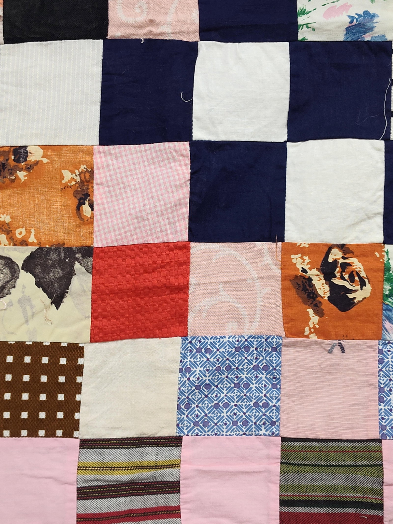 Postage Stamp Scrap Quilt Top w/ Recycled Sack: A mid-to-late 20th century unfinished quilt top constructed in a postage stamp or scrap patchwork style. The piece is composed of numerous small fabric squares, approximately 2 inches in size, machine