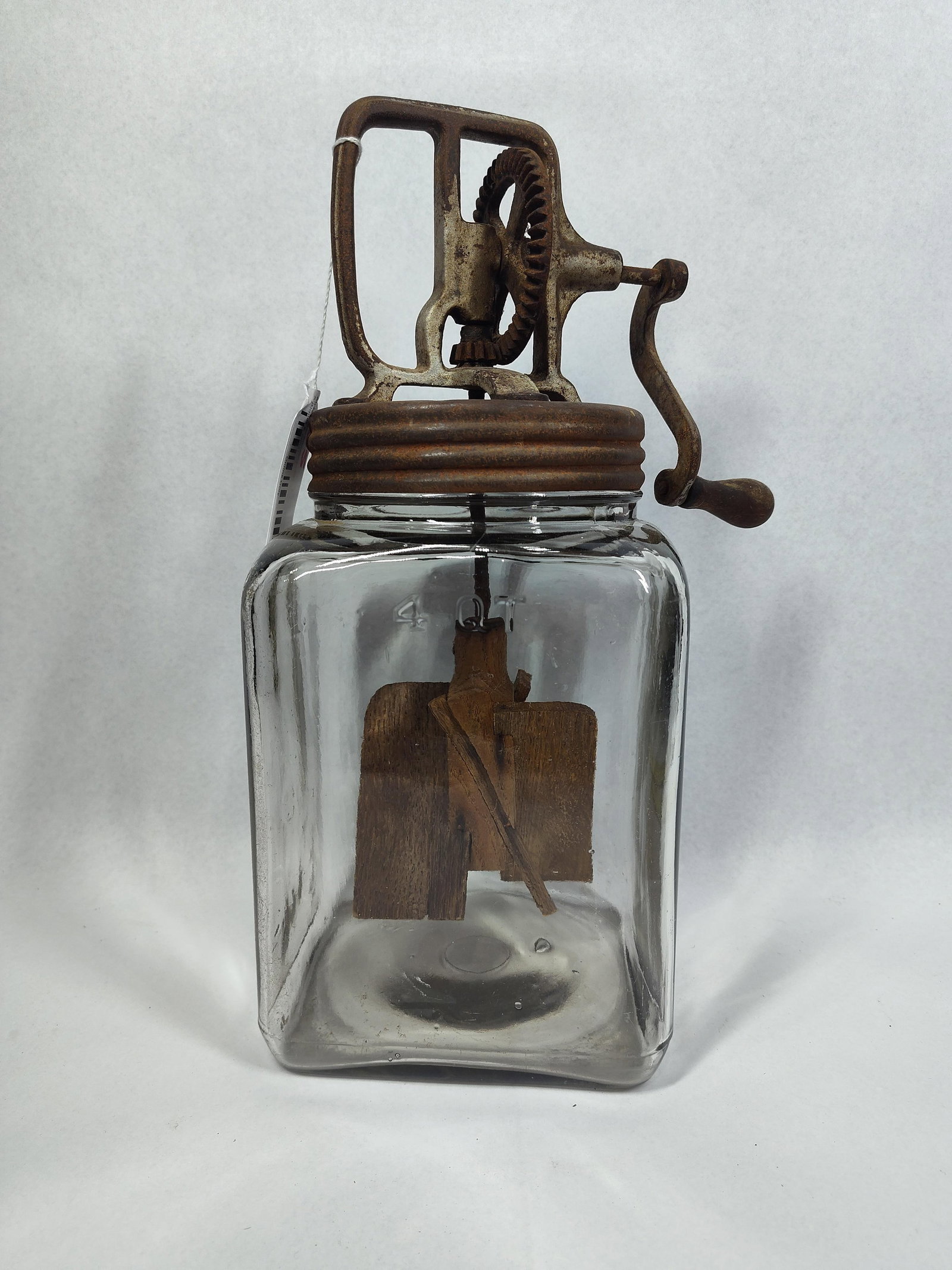 Dazey Hand-Crank Glass Butter Churn: An antique hand-cranked glass butter churn, attributed to the Dazey Churn and Manufacturing Company 14in tall and resembling the No. 40 model. The device features a molded clear glass jar with a