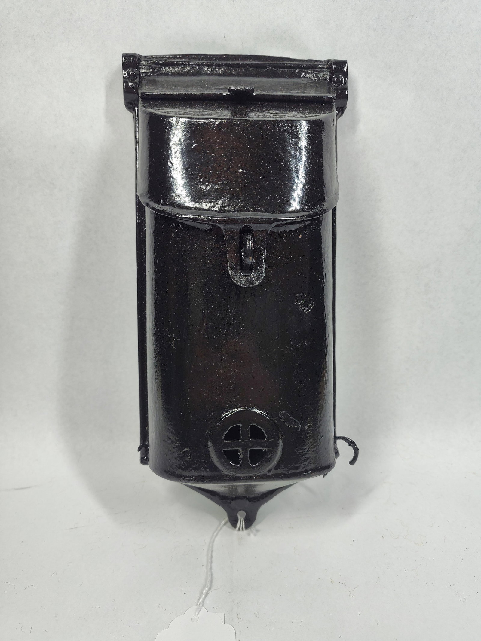 Griswold Attributed Iron Wall Mailbox: Attributed to Griswold, this antique wall-mounted mailbox is constructed of heavy cast iron with a black painted finish measuring 5.5x12in. The design features a vertical, slender body with a rounded