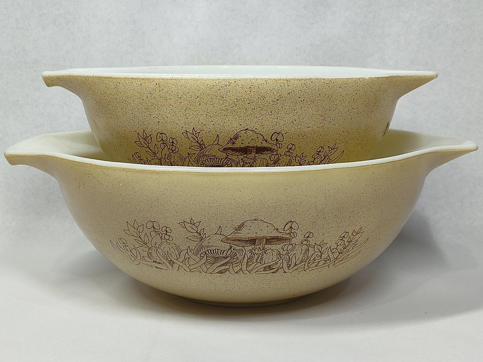Pair Pyrex Forest Fancies Mixing Bowls: This is a matching pair of vintage mixing bowls produced by Corning Glass Works under the Pyrex brand. The bowls feature the Forest Fancies pattern, which was manufactured between 1981 and 1986. Each 