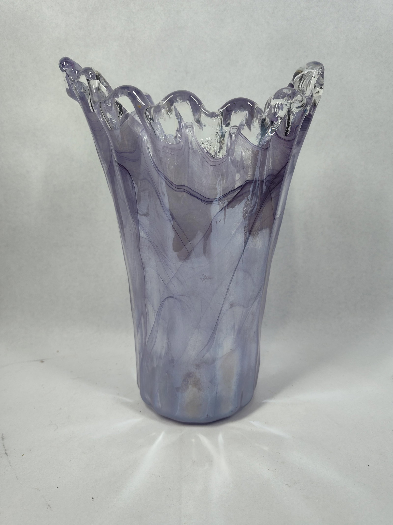 Murano Style Lavender Swirl Glass Vase: 11.5x8x8 Attributed to Murano, this hand blown art glass vase features a flared, organic form with a multi-pointed undulating rim. The body is characterized by a marbled swirl pattern in shades of lav