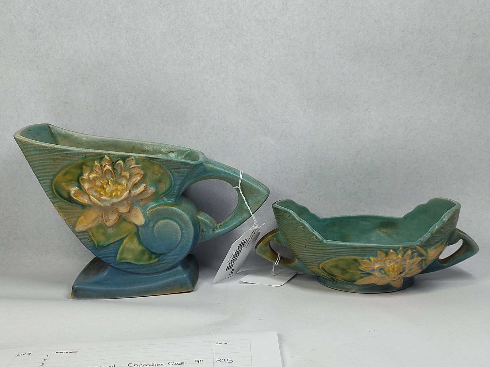 Pair Roseville Water Lily Art Pottery: 3 and 5.5in tall. This lot consists of two pieces of American art pottery produced by Roseville Pottery in the Water Lily pattern, which was introduced in 1943. The set is finished in a matte teal blu