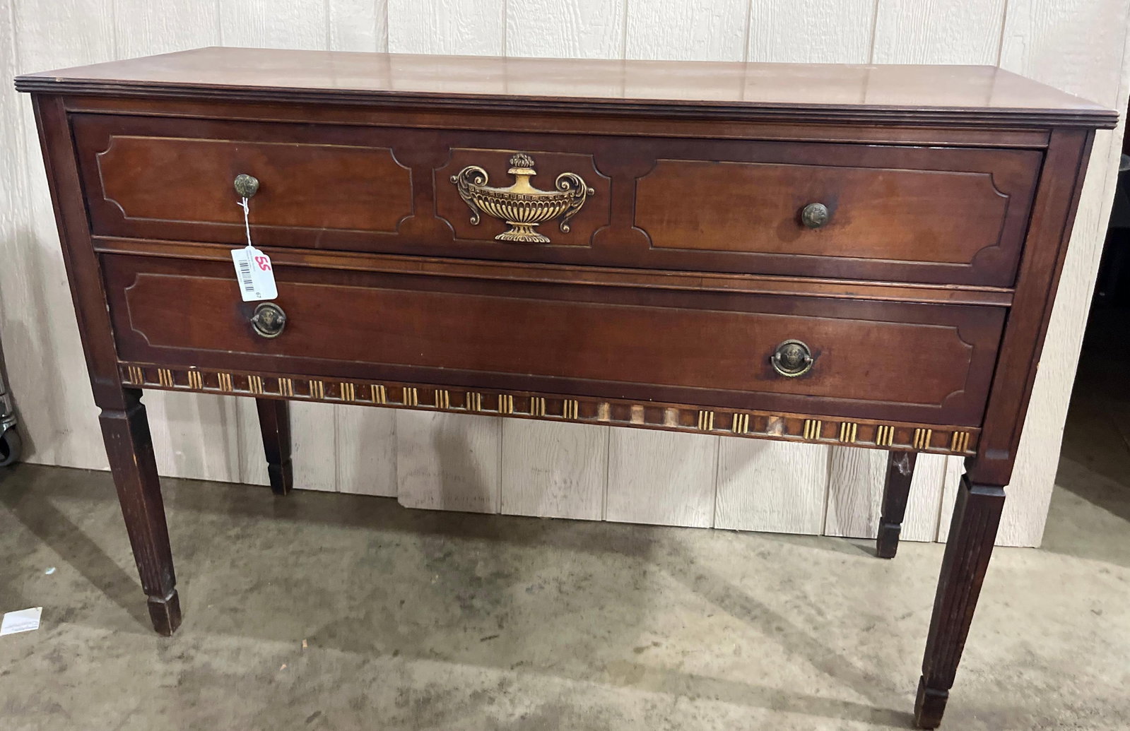 Federal Revival Mahogany Server: 48x18x33 This mid-20th-century two-drawer server is designed in the Federal Revival style, constructed primarily of mahogany with a dark reddish-brown finish. The rectangular case features a top with