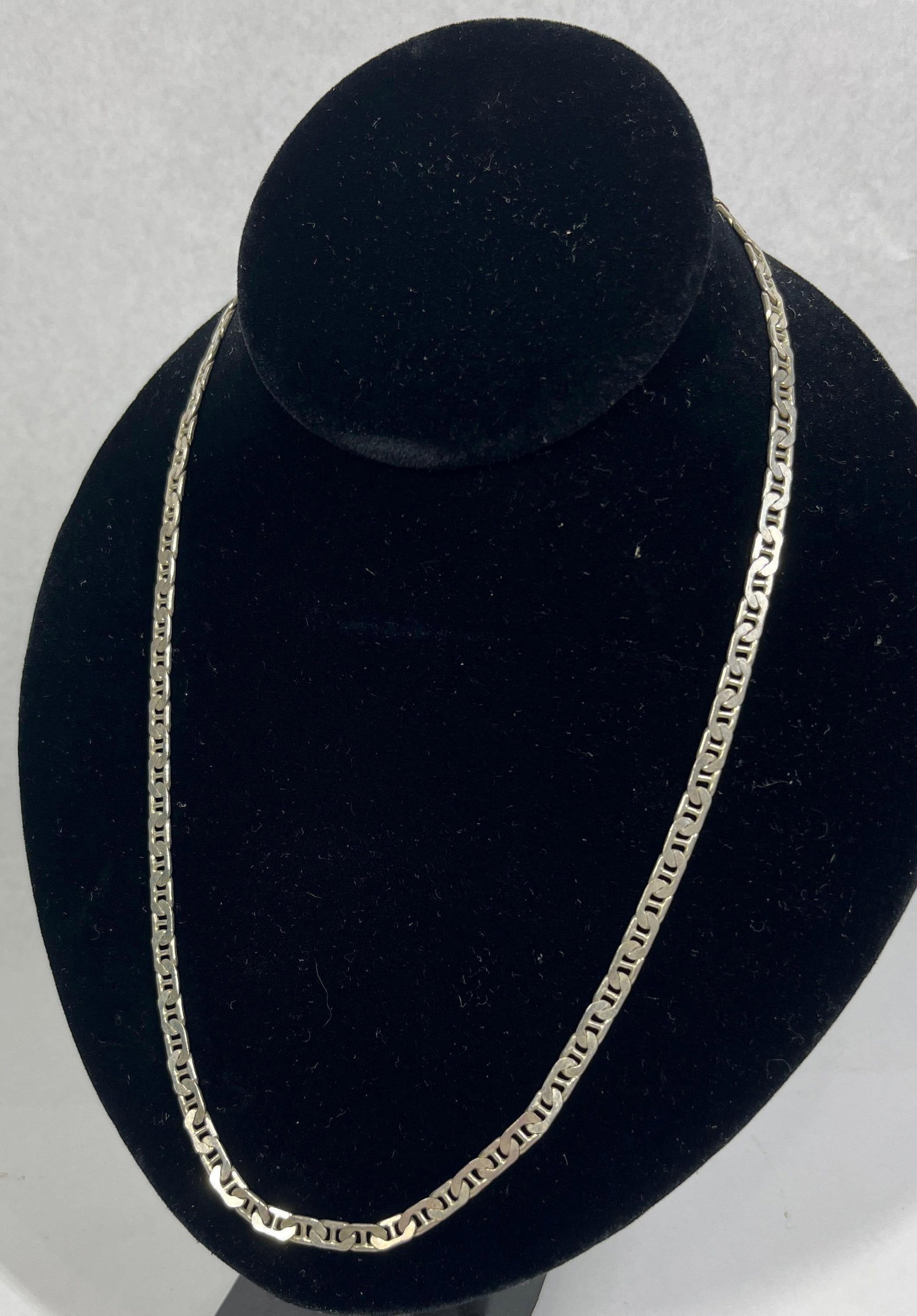 Italian Sterling Flat Mariner Link Necklace: An Italian-made flat mariner link chain necklace, also known as an anchor link chain. The necklace is crafted from sterling silver and features a lobster claw clasp. The end caps and the clasp assembl