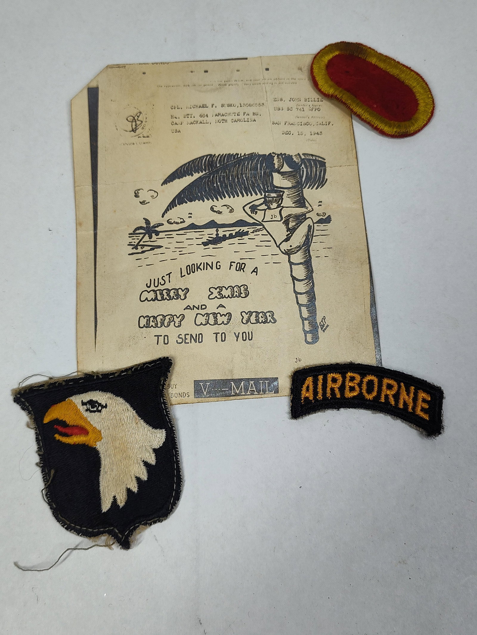 A Collection of WWII US Army Airborne and US Navy Identified Ephemera and Insignia: This collection consists of original World War II military artifacts associated with Corporal Michael F. Susko of the 464th Parachute Field Artillery Battalion. The lot includes an original V-Mail hol