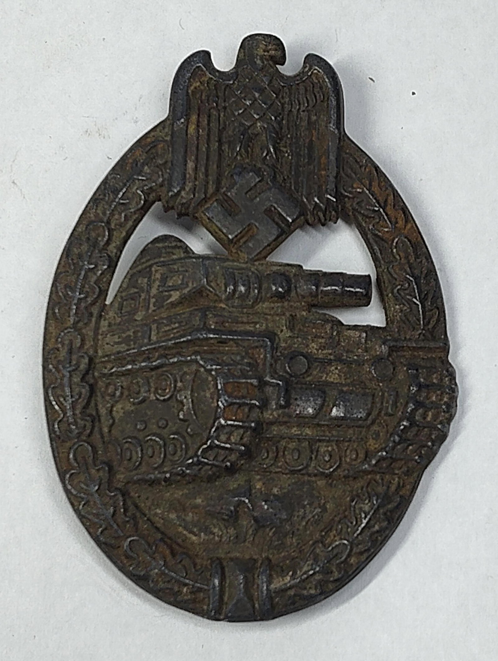 WWII German Heer Panzer Assault Badge in Silver by Karl Wurster: This badge is a die-struck zinc Panzer Assault Badge in silver grade, a combat award established in 1939 for armored unit personnel. It features a solid-back construction characteristic of the manufac