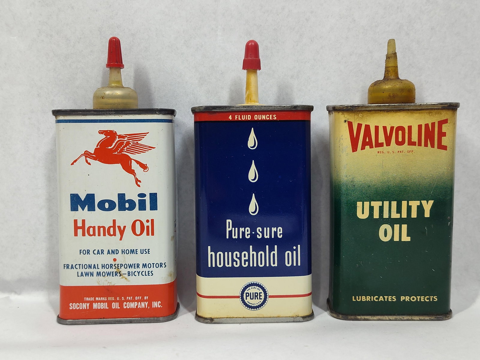 3 Mobil, Pure & Valvoline Oil Cans: This lot features three mid-20th-century tin-lithograph handy oilers produced for automotive and household use. The collection includes one Mobil Handy Oil can featuring the iconic red Pegasus logo. T
