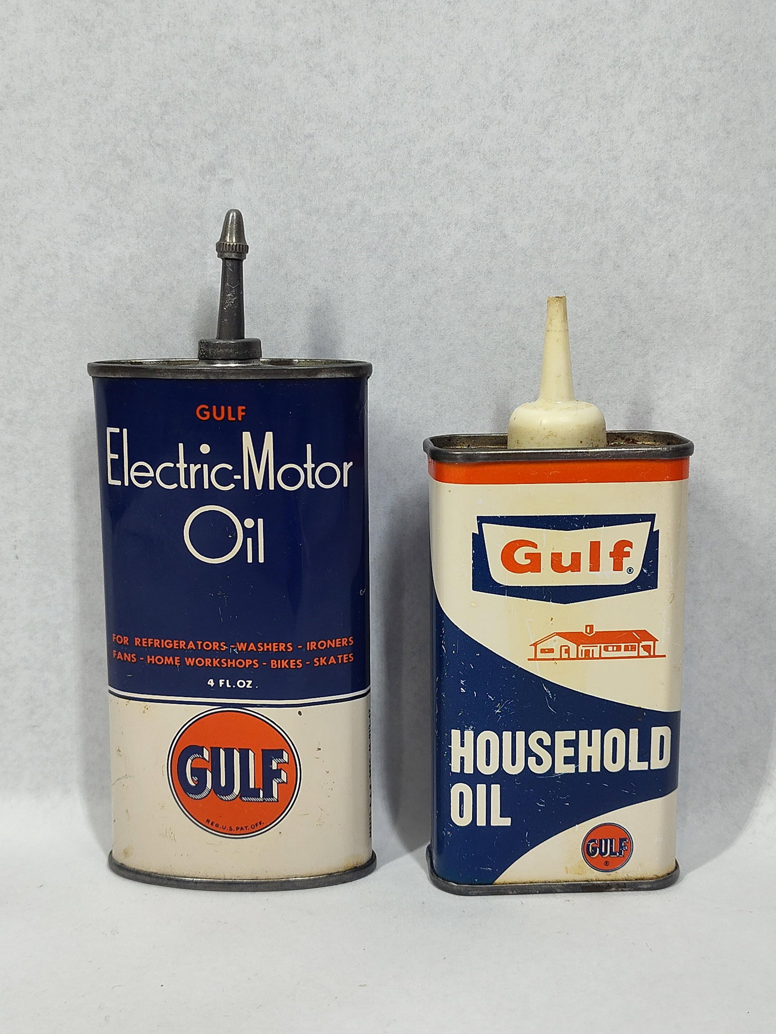 Pair Gulf Oil Handy Oiler Cans, 20th C: This lot features a pair of vintage lithographed tin utility oil cans produced by the Gulf Oil Corporation of Pittsburgh, Pennsylvania. The first can is for Gulf Electric-Motor Oil and features a