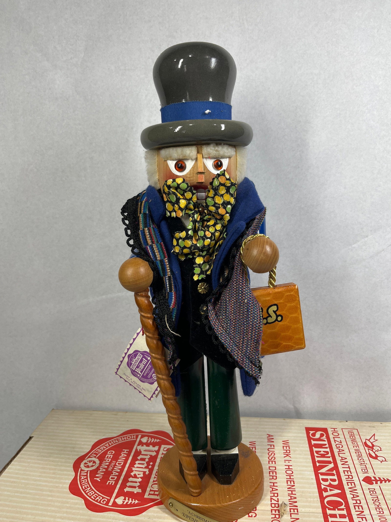 Steinbach Ebenezer Scrooge Nutcracker: 18.5in tall This handcrafted wooden nutcracker represents the character Ebenezer Scrooge from Charles Dickens's A Christmas Carol, produced by the German manufacturer Steinbach GmbH. The figure is