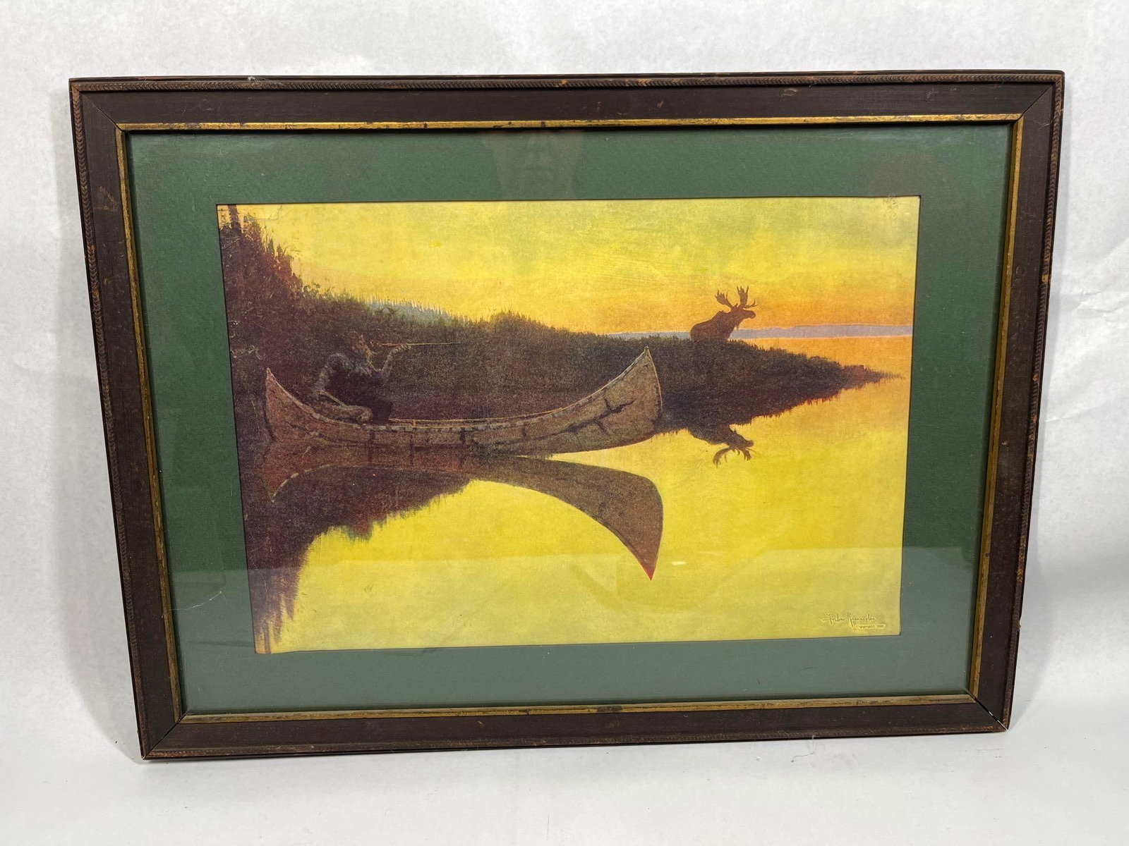 F. Remington, Coming to the Call Print: 21x15.5 This color print by Frederic Remington is titled Coming to the Call. The artwork depicts a wilderness nocturne scene featuring a man in a birchbark canoe using a call to attract a bull moose