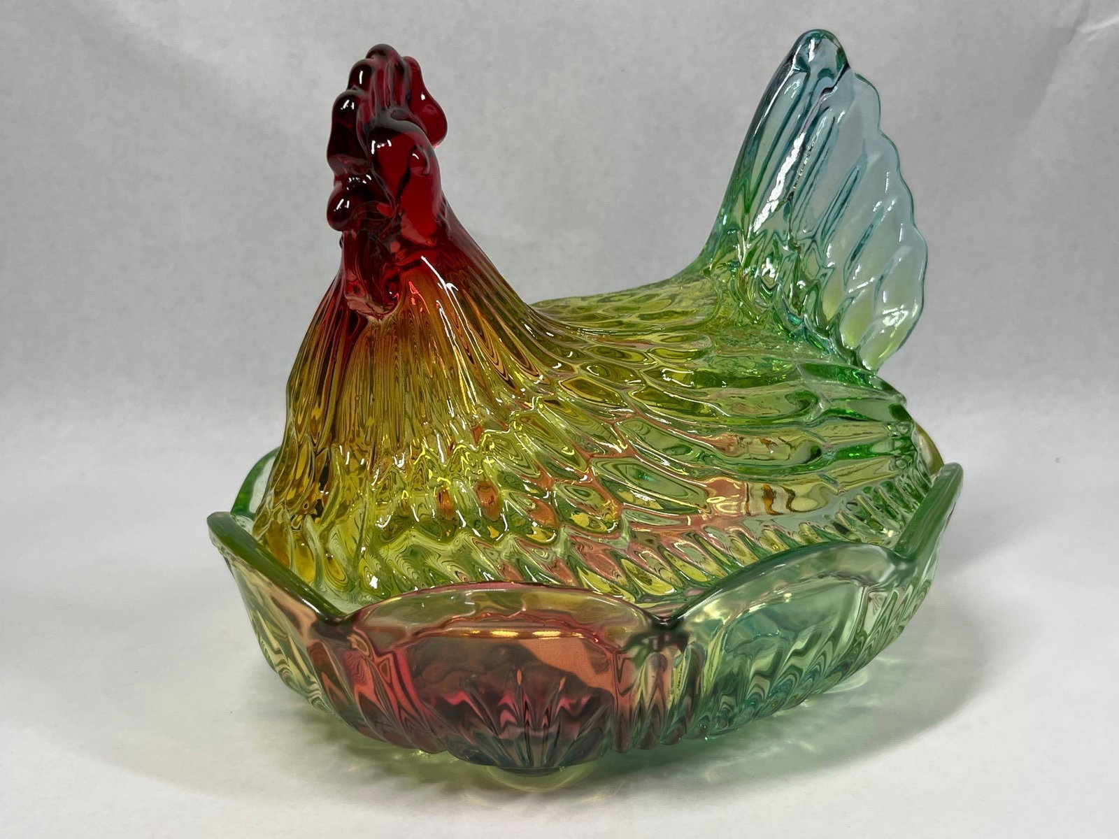 Imperial Rainbow Slag Hen on Nest Dish: 9x6x7 This is a two-piece covered glass dish manufactured by the Imperial Glass Company of Bellaire, Ohio. The piece is designed in the classic Hen on Nest form, featuring a lid shaped as a nesting he