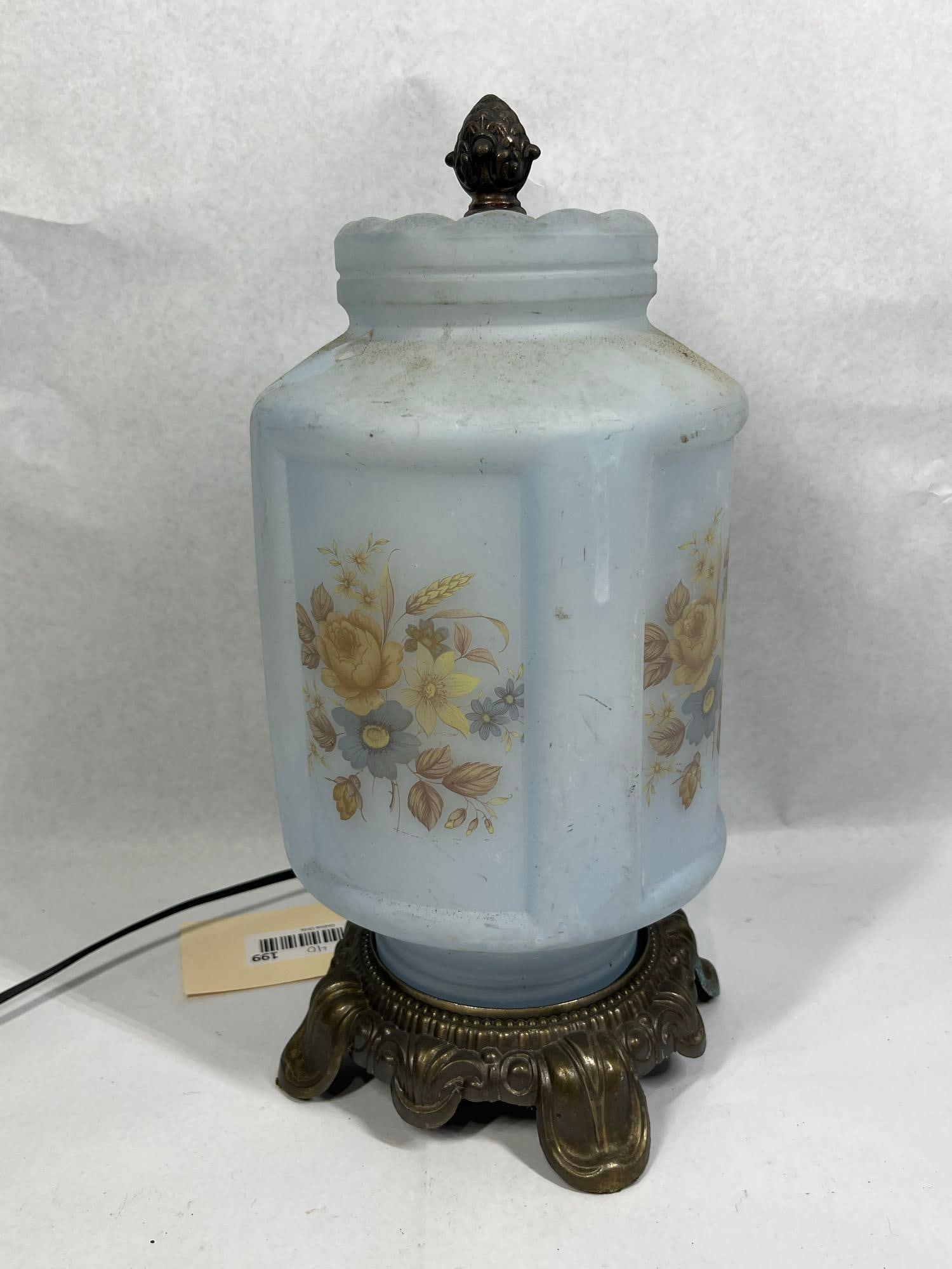 Powder Blue Milk Glass Floral Lamp: 13.5in tall This vintage table lamp features a faceted octagonal body constructed of powder blue milk glass. The glass is decorated on multiple panels with transfer-printed floral motifs, including