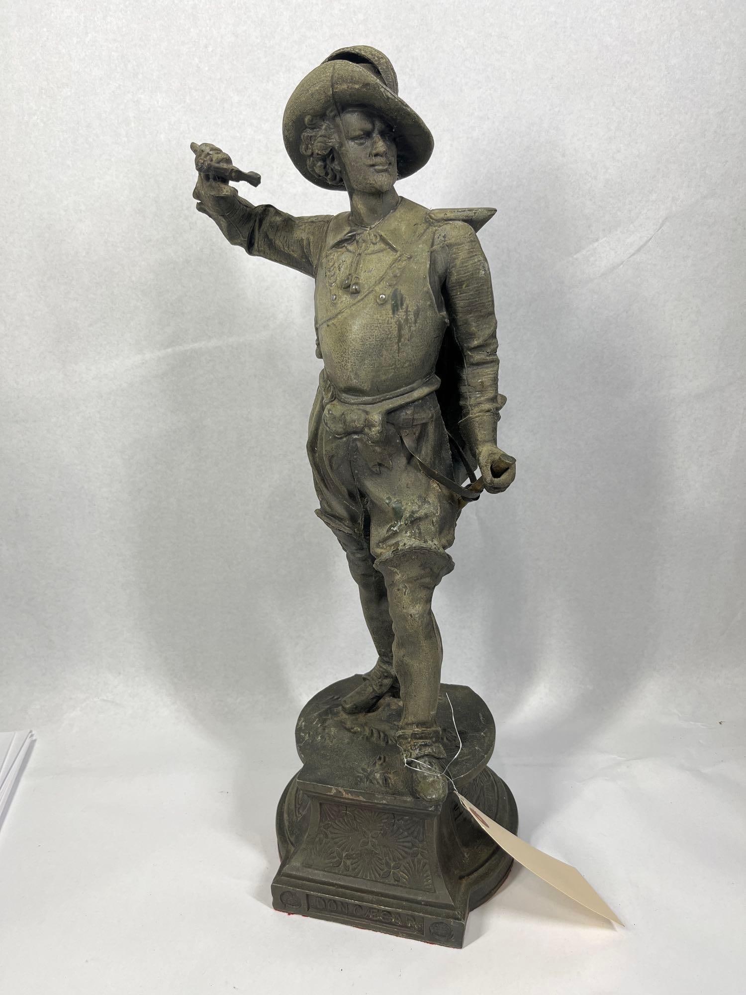 After P. Poitevin Don Cesar Sculpture: This cast metal sculpture is manufactured from spelter with a dark brown patinated finish. It depicts the theatrical character Don Cesar de Bazan in 17th-century cavalier attire, featuring a