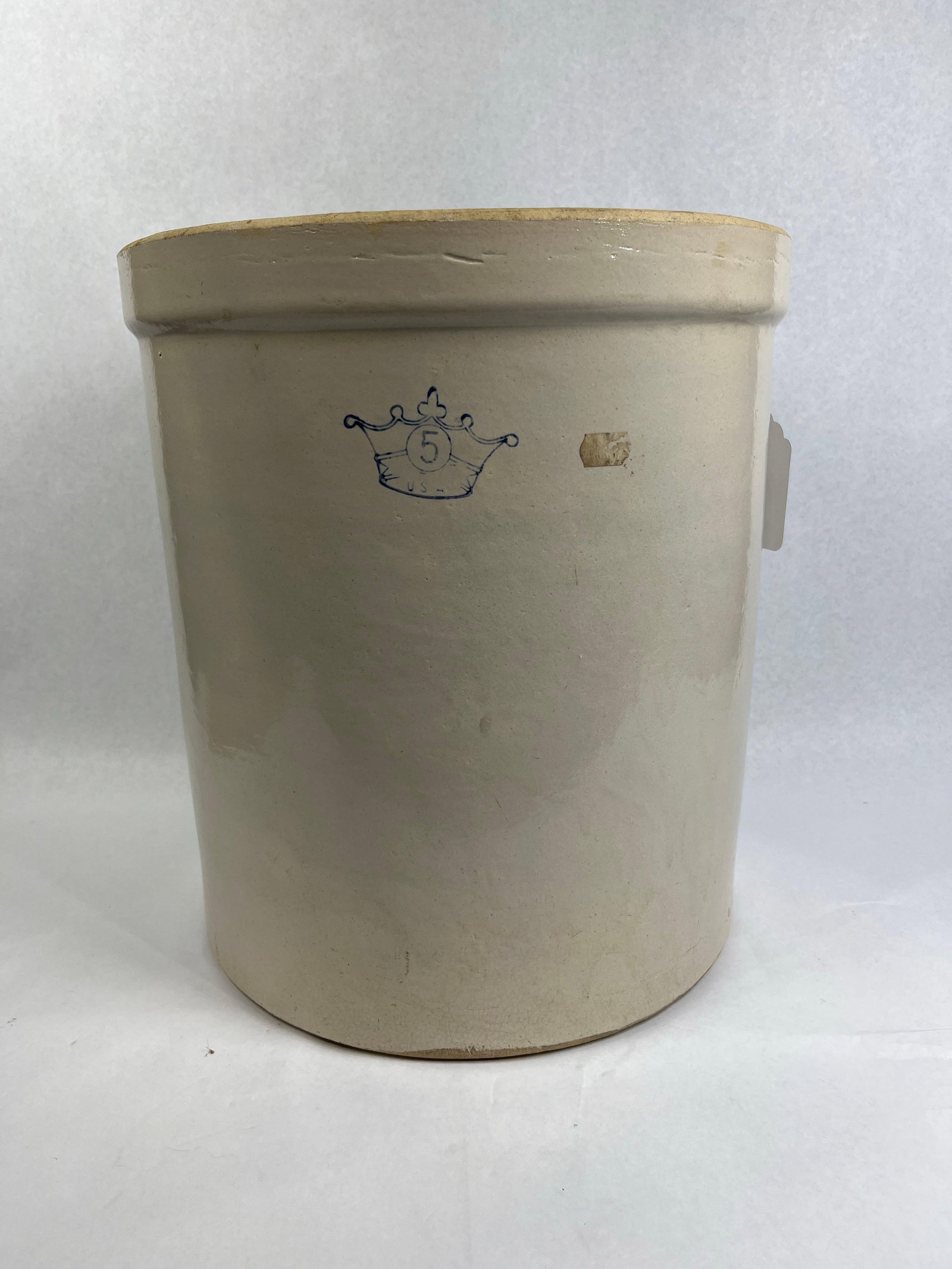 Robinson-Ransbottom Blue Crown Crock: 14x12 This cylindrical stoneware storage crock was manufactured by the Robinson-Ransbottom Pottery Company in Roseville, Ohio. The vessel features a thick, rolled rim and a flat, unglazed base. The