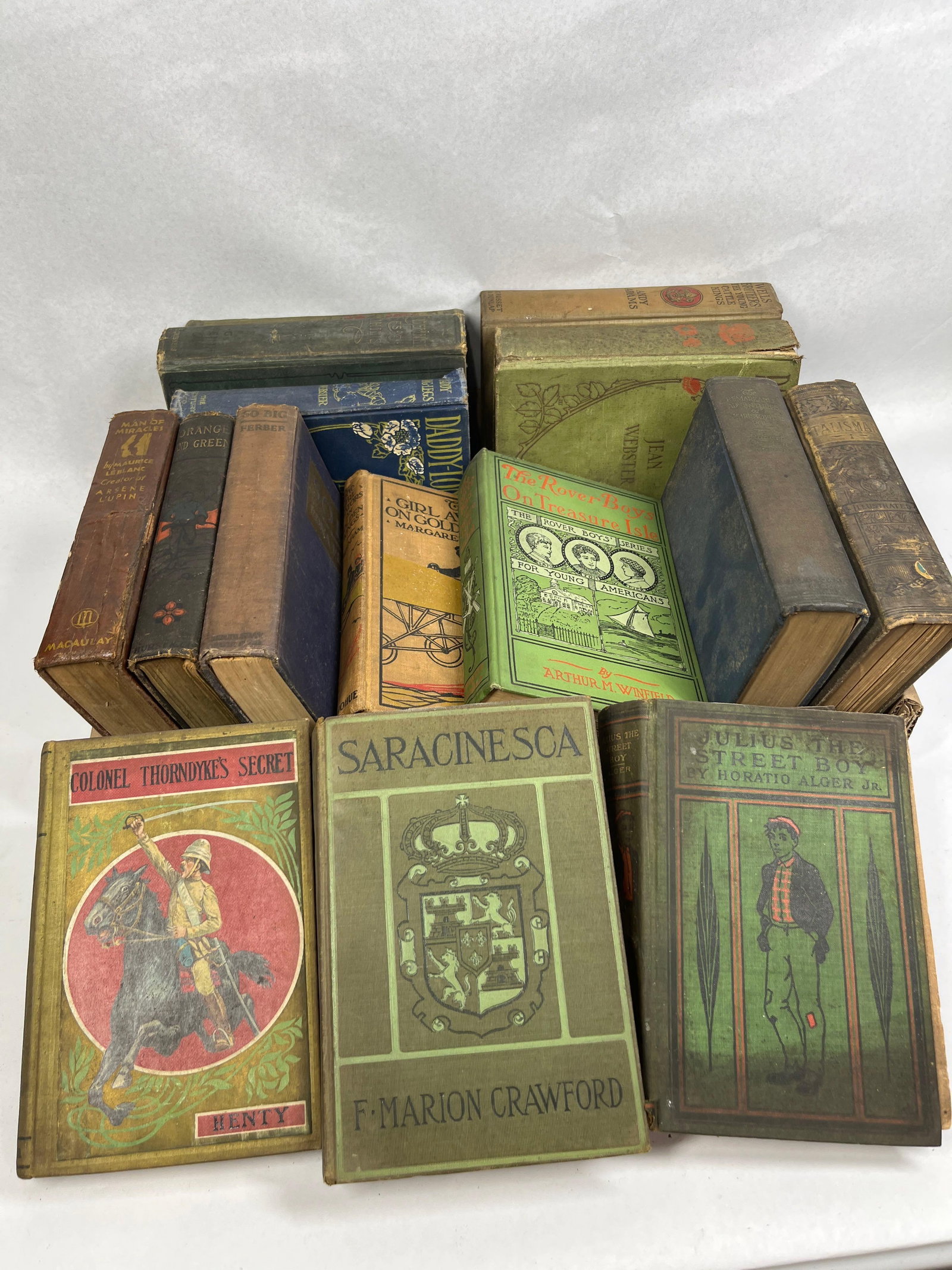 Early 20th C. Adventure & Juvenile Vols: This collection comprises an assortment of vintage cloth-bound hardcover books, primarily consisting of early 20th-century adventure and children's literature. Key publishers represented in the