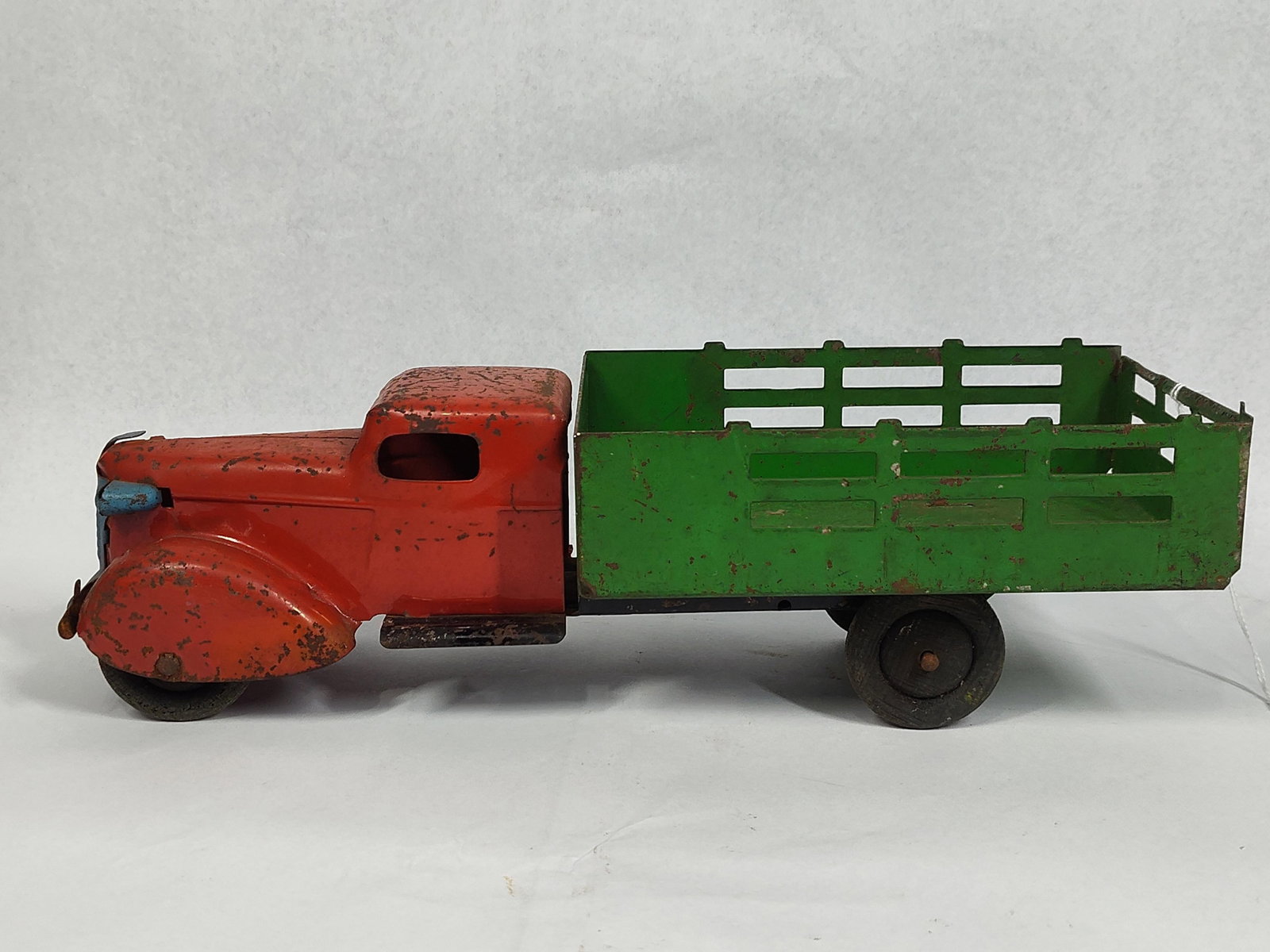 Wyandotte Pressed Steel Stake Truck: 12in long This vintage pressed steel toy truck is attributed to Wyandotte Toys (All Metal Products Co.) based on the characteristic streamlined cab design and distinctive front grill assembly from