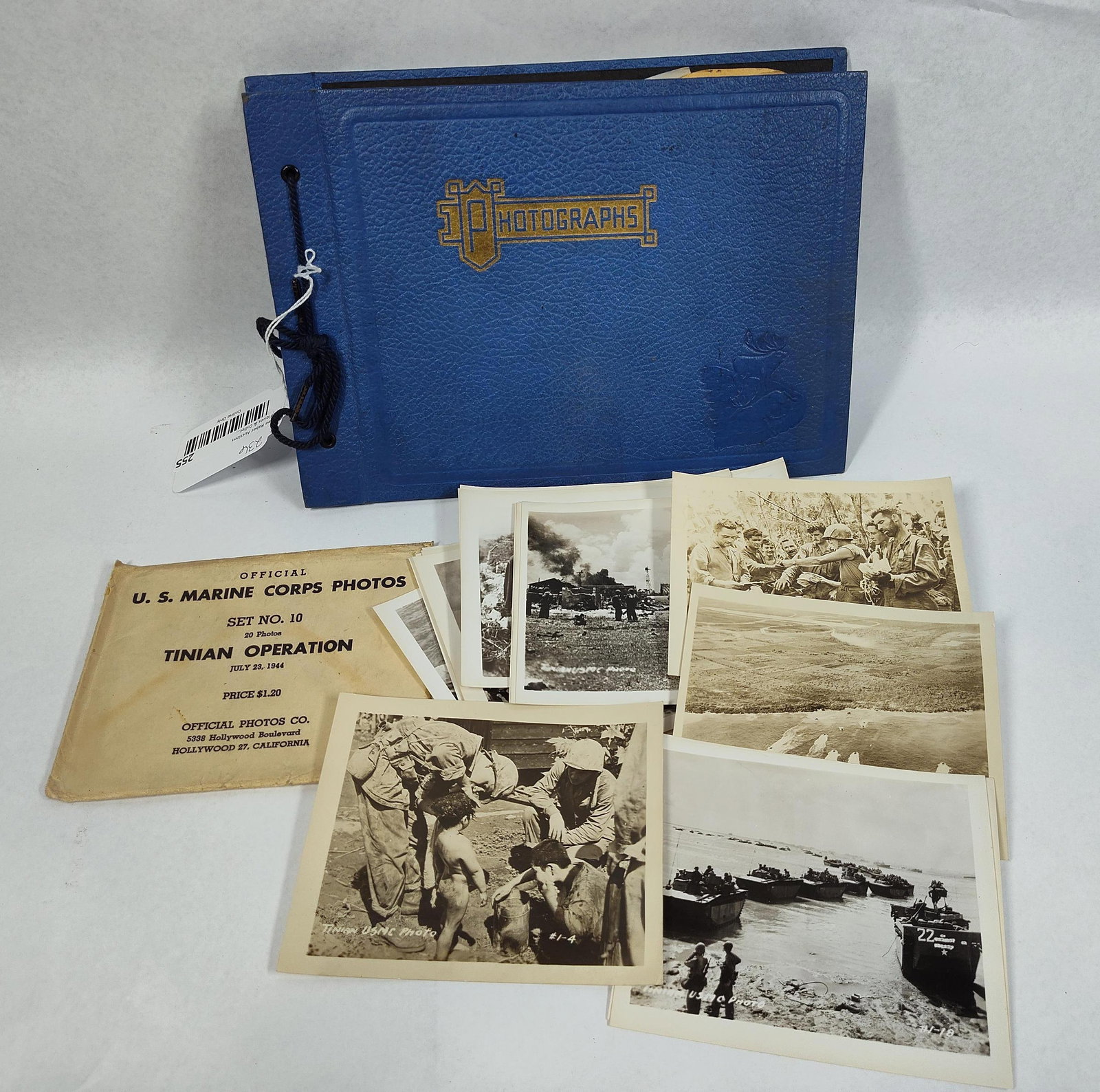 WWII USMC Tinian Combat Photos & Album: This lot comprises a collection of World War II-era United States Marine Corps photographs and a personal photograph album. The primary component is an official set of black-and-white combat