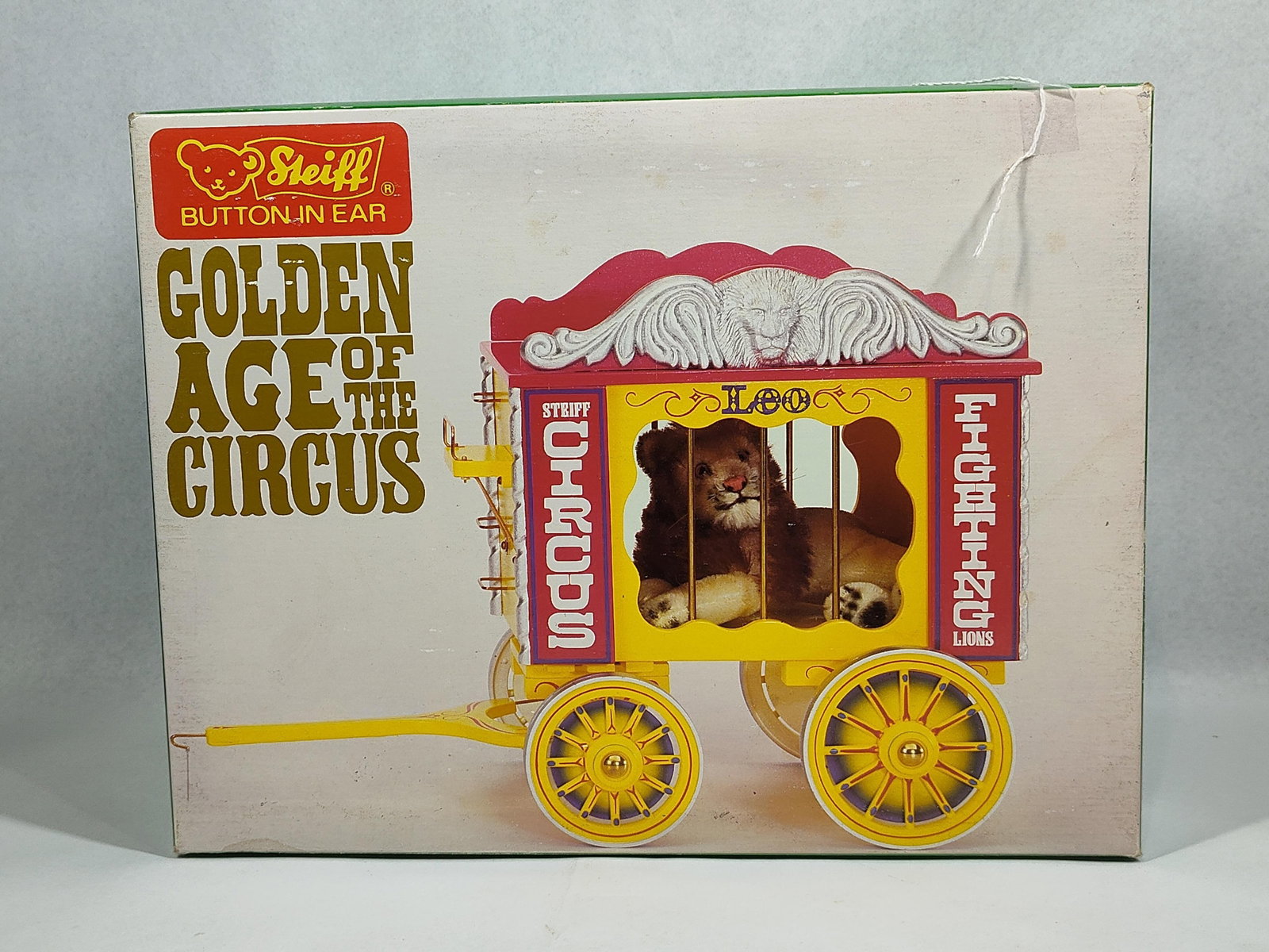 Steiff Golden Age Leo Lion & Wagon Set: This Steiff Golden Age of the Circus limited edition set includes a mohair Leo the Lion figure and a wooden circus cage wagon. Identified as style number 0100/87, this is the second wagon in a series