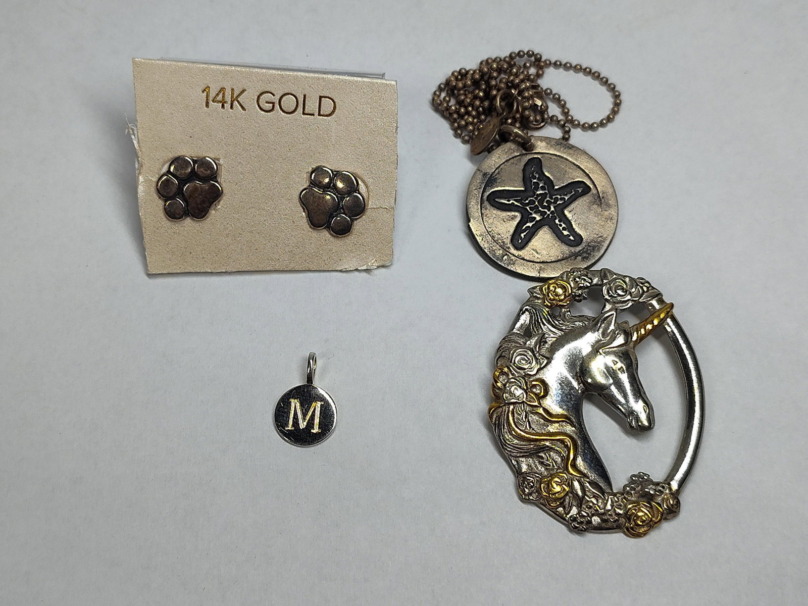 Gorham Unicorn, Str. & 14K Gold Jewelry: An assortment of jewelry featuring sterling silver and 14 karat gold components. The collection includes a notable oval openwork pendant by Gorham, featuring a unicorn head in profile surrounded by a 