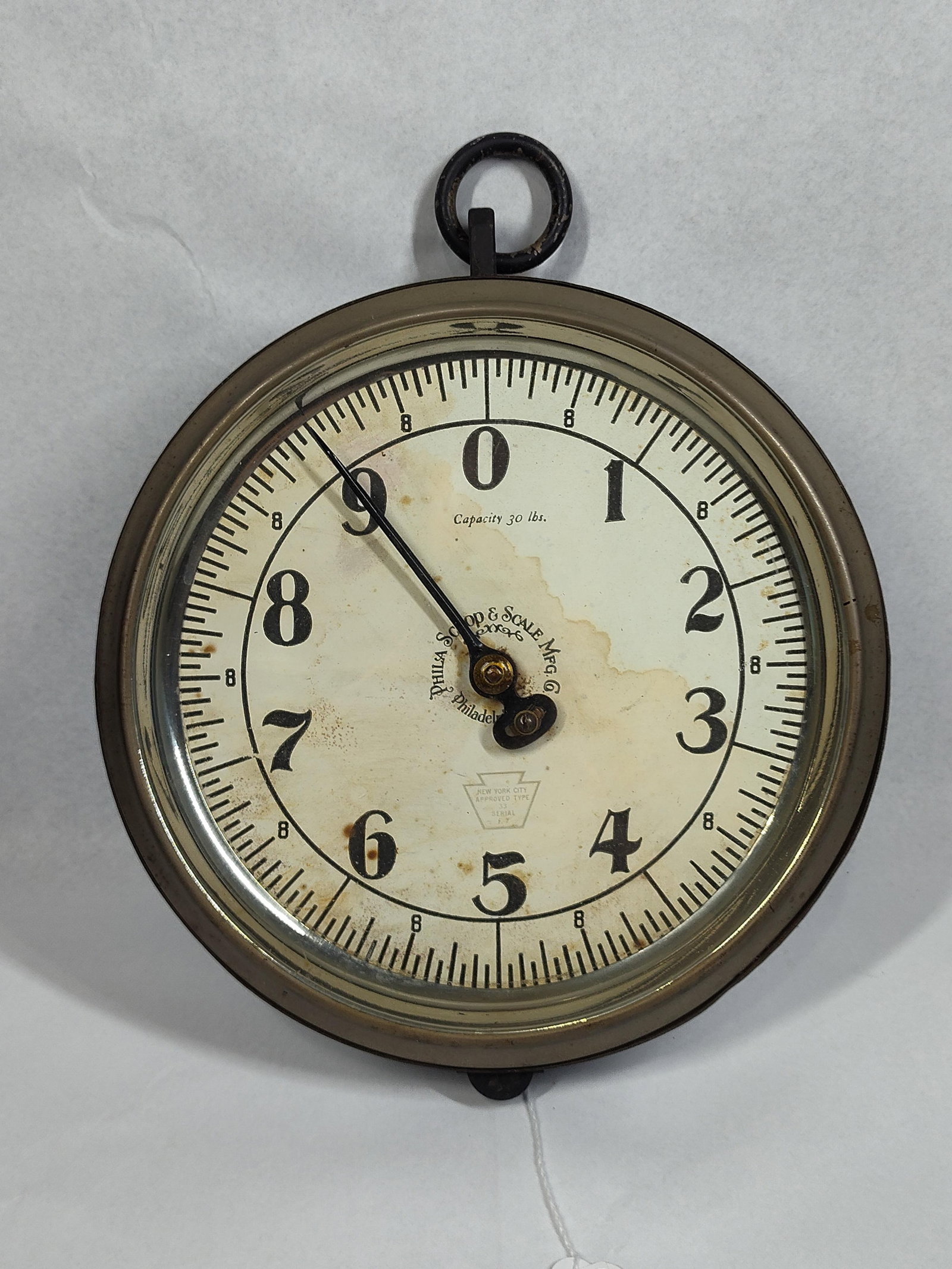 Philadelphia Scoop & Scale Spring Scale: 10in An antique circular hanging spring scale manufactured by the Philadelphia Scoop and Scale Manufacturing Company of Philadelphia, Pennsylvania. The instrument features a heavy cast metal